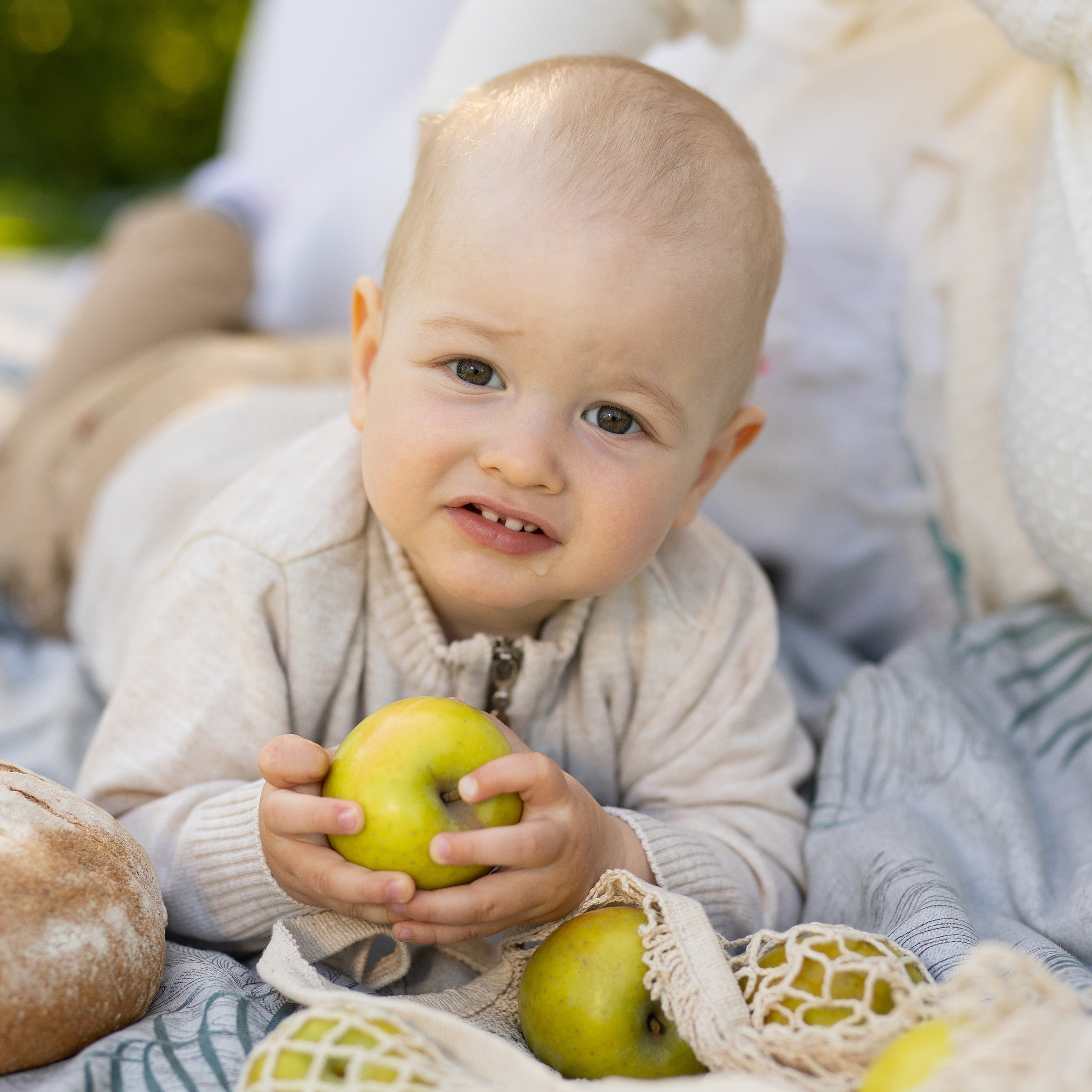 малыш держит яблоко