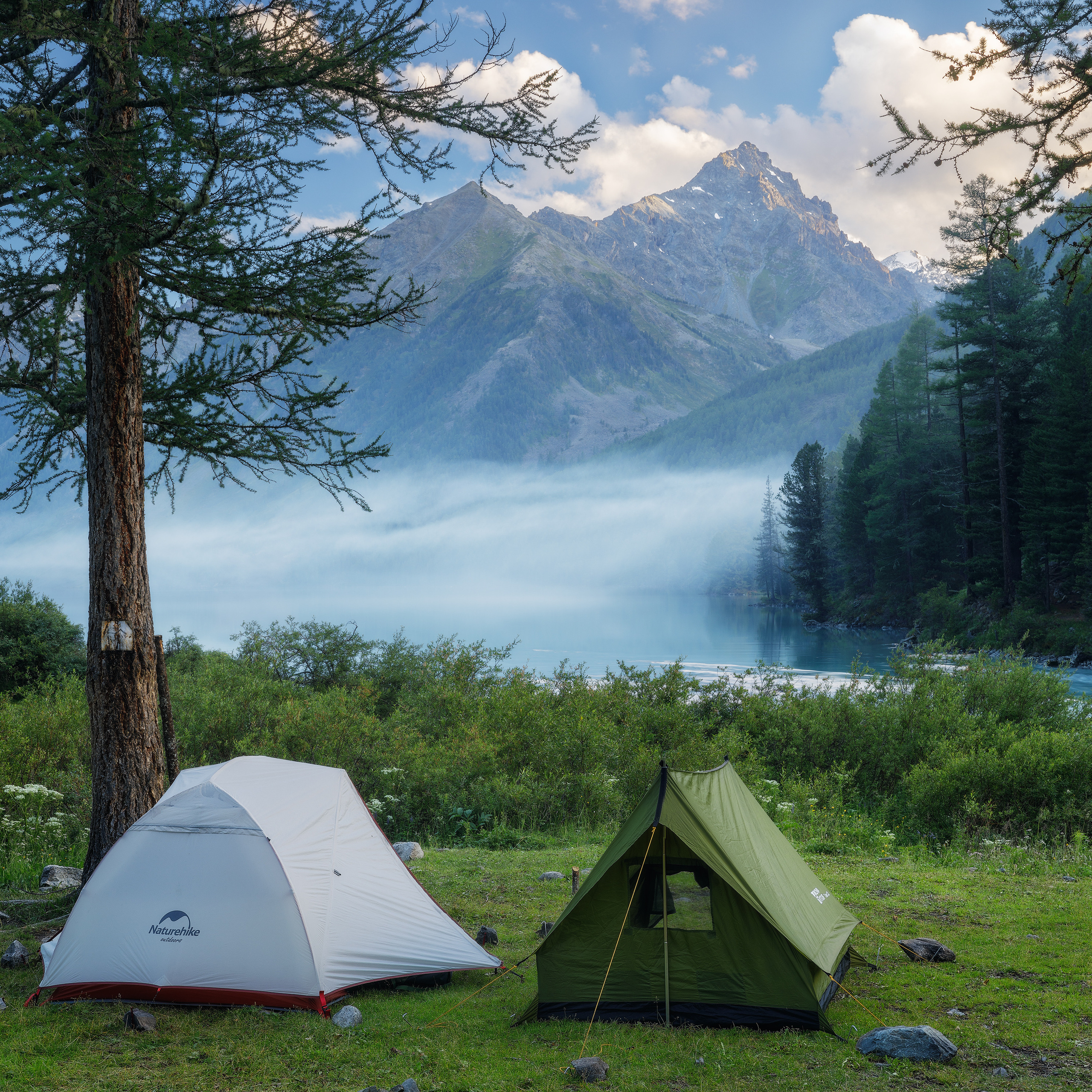 Алтайские горы. Горный пейзаж. Поход в горы. Озеро между гор. Кучерлинское озеро. Палатки на фоне гор. Туман над горным озером. Республика Алтай.
