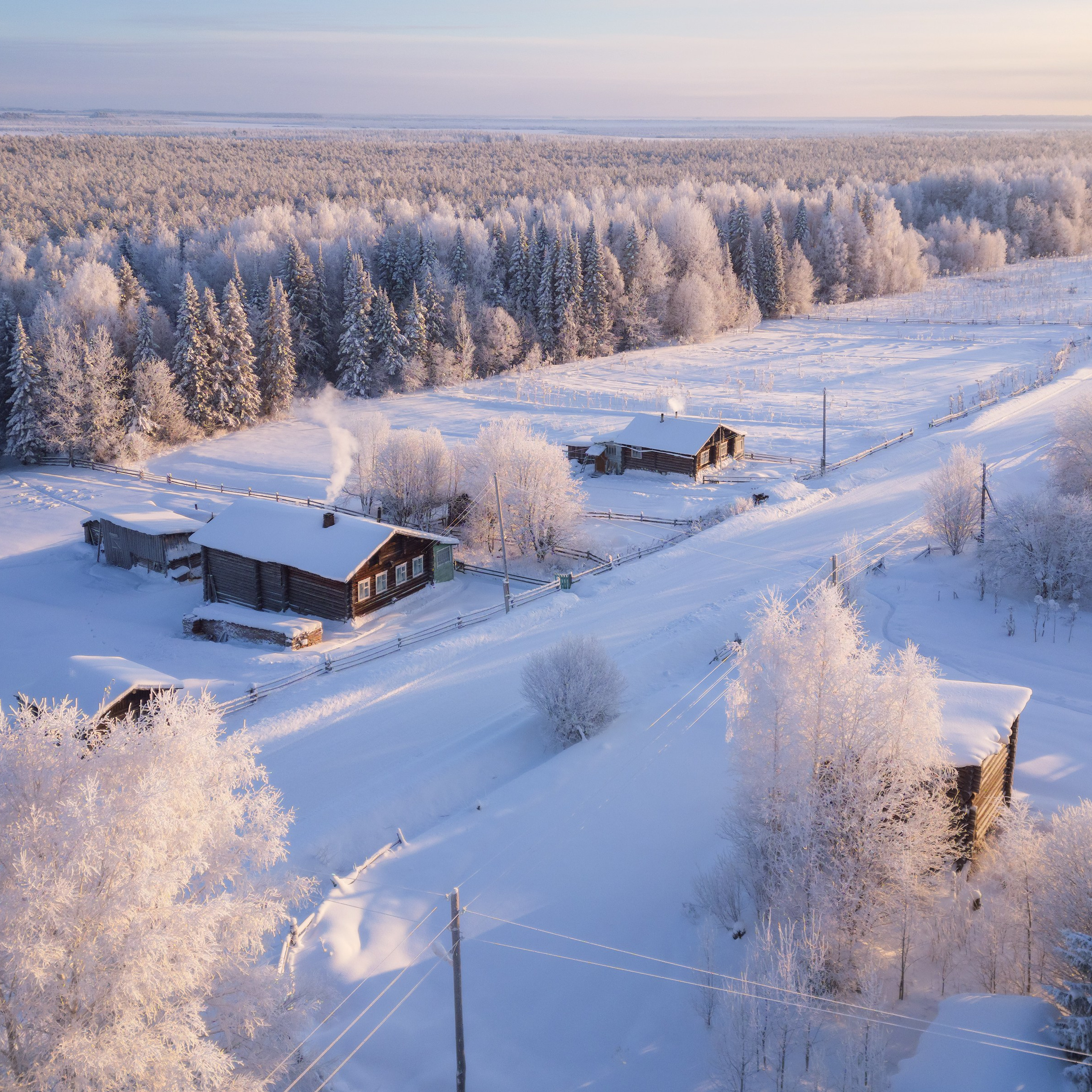 The outskirts of the village of Don from a drone. Komi Republic, Ust-Kulomsky district. Sunset on a frosty winter day.