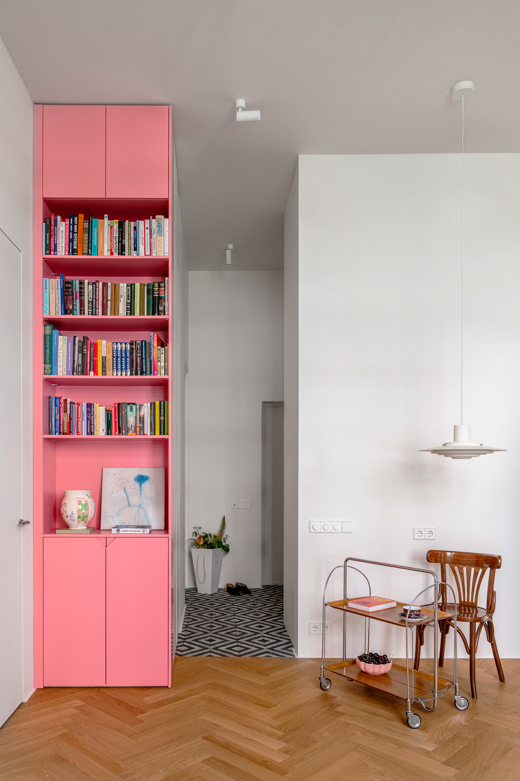 Pink shelving beside the dining area
