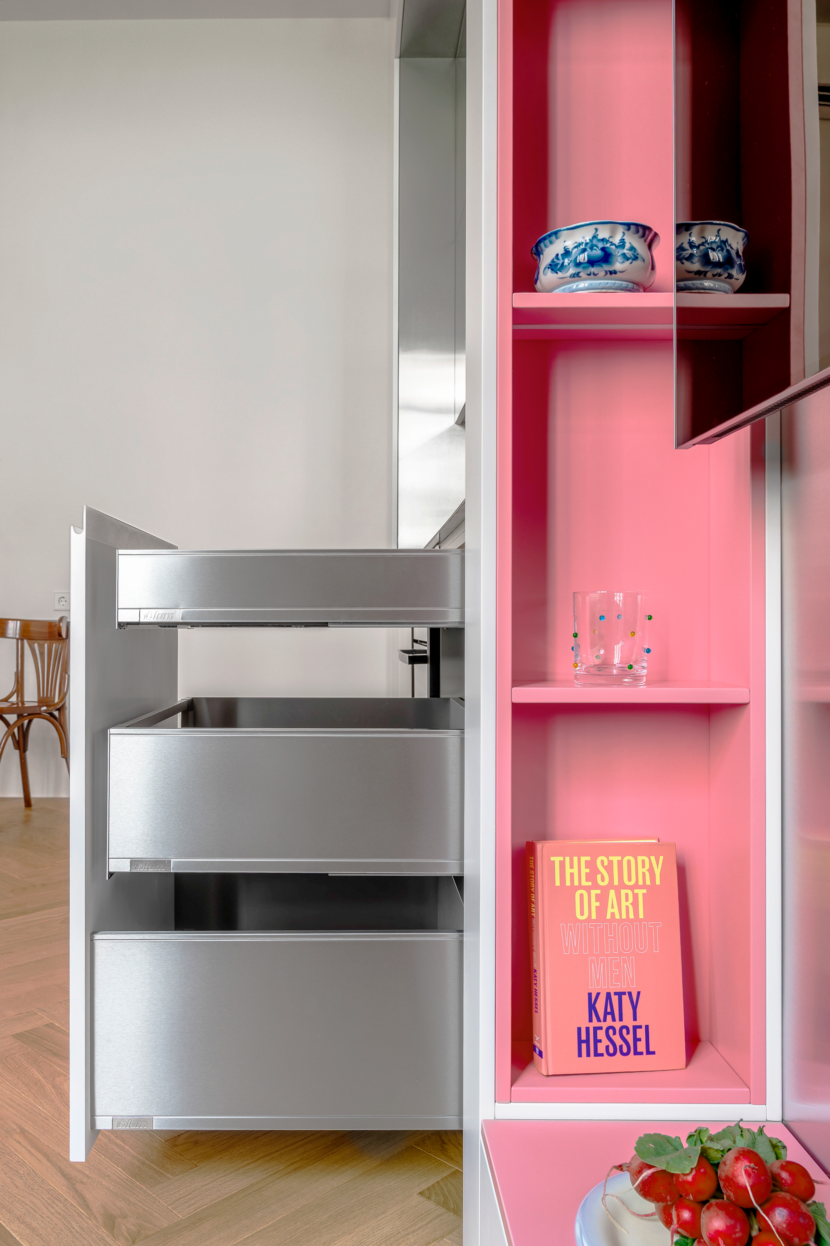 Pull-out drawers beside the pink bookshelves