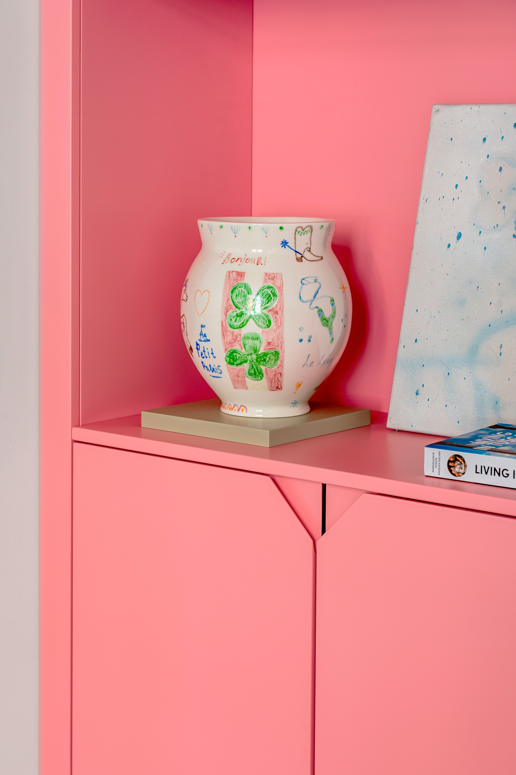 Decorative vase on a pink shelf