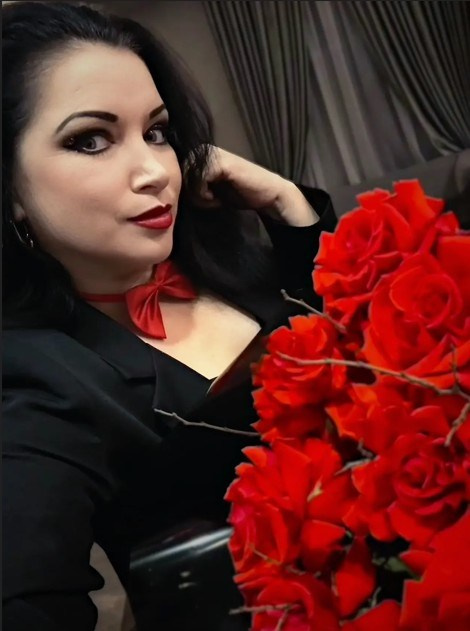 Ведущая Марина Гребенникова из Волгодонска, выступает на сцене, использует жесты и улыбается, создавая атмосферу веселья.