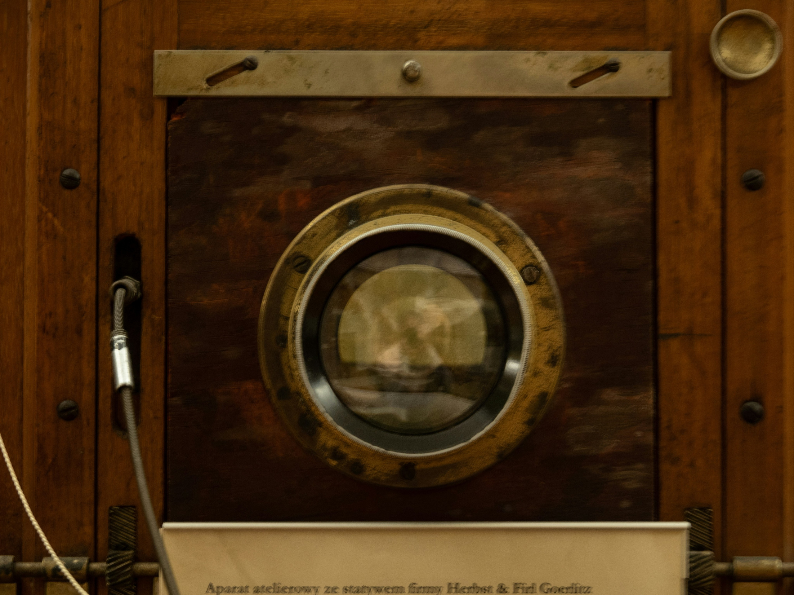 A vintage Camera Obscura lens mounted on a wooden box, showcasing old photography equipment