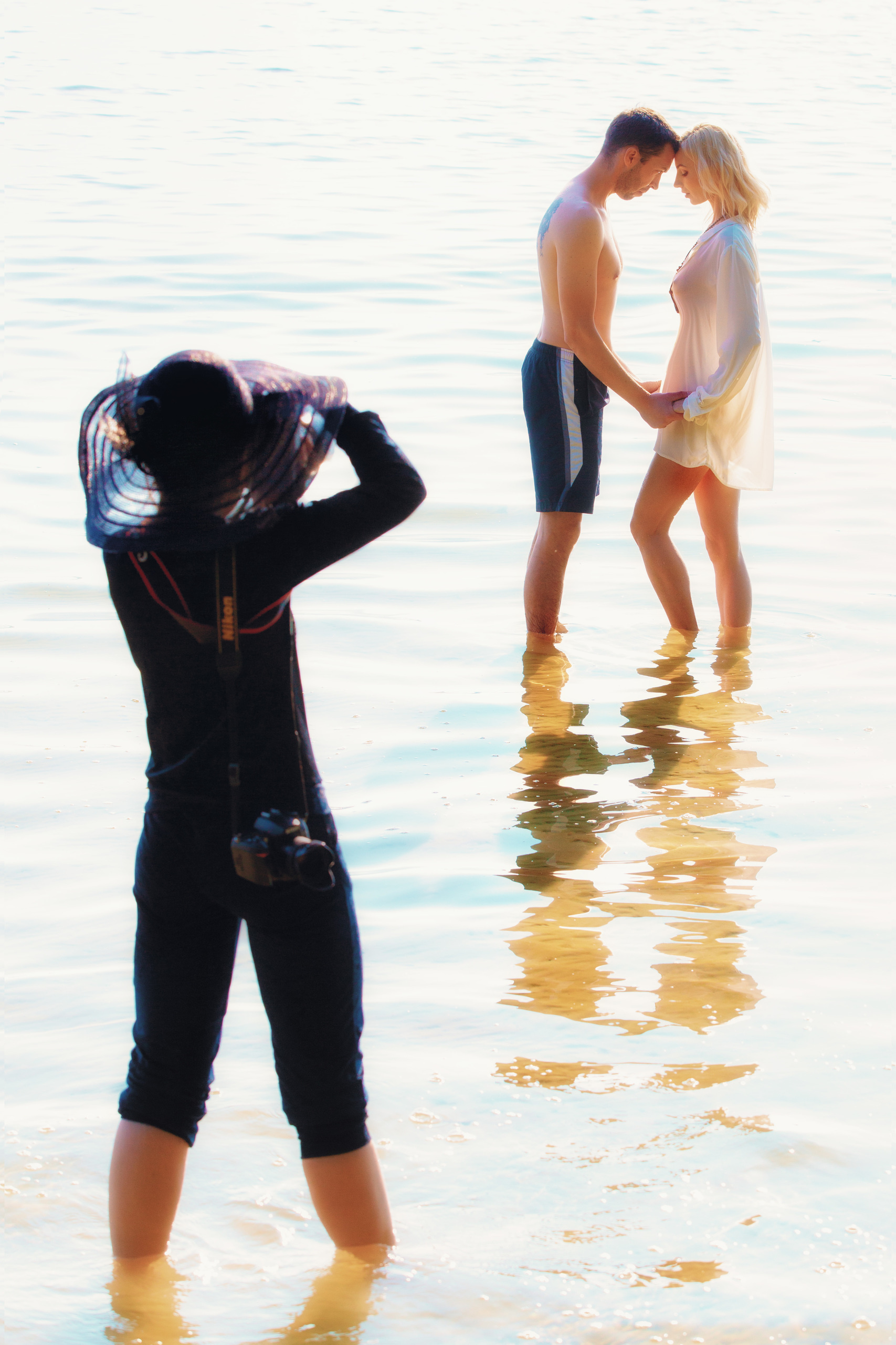 фотограф снимает стоящих рядом парня и девушку