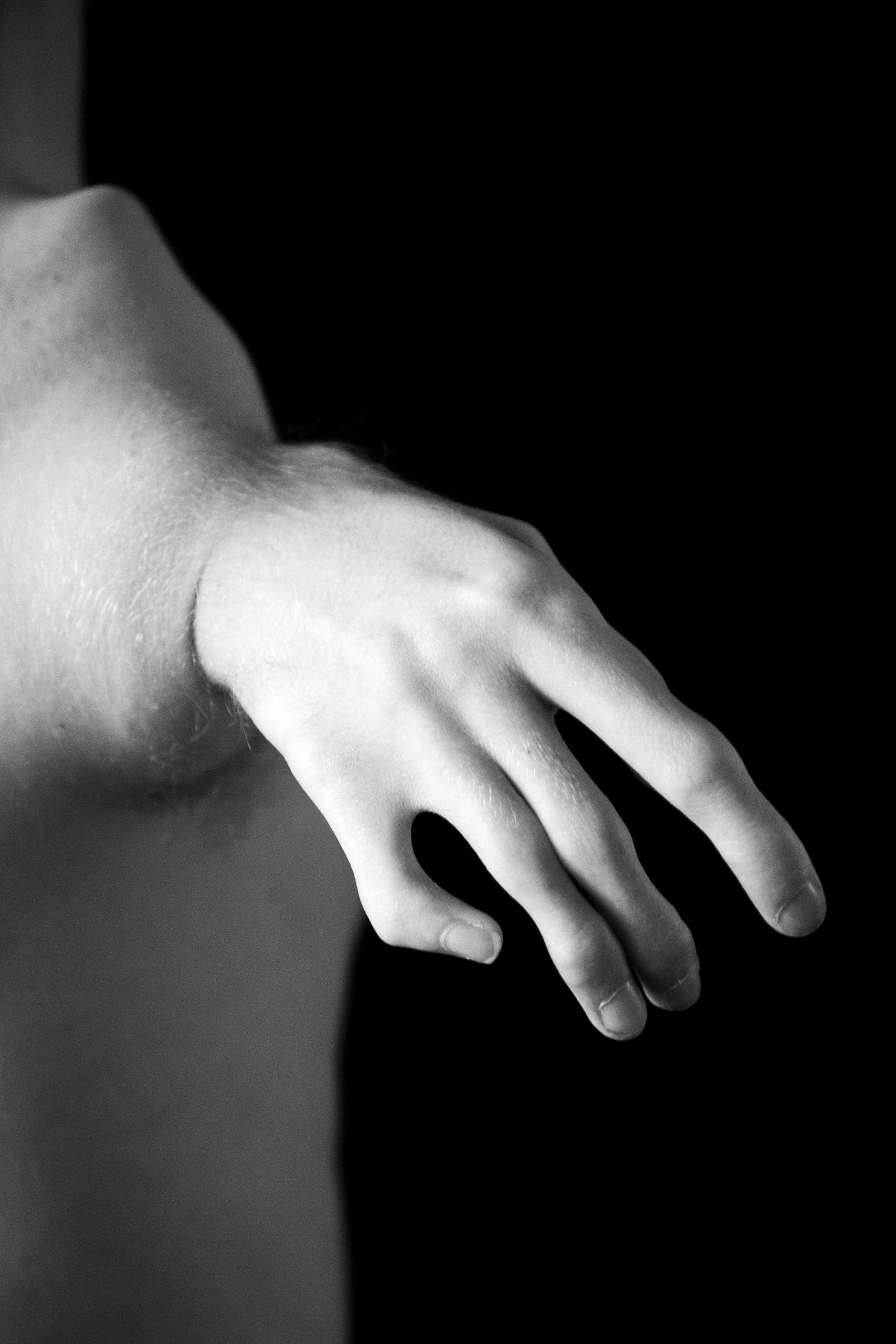 Conceptual black and white close-up photo, lines and aesthetics of a body on a black background