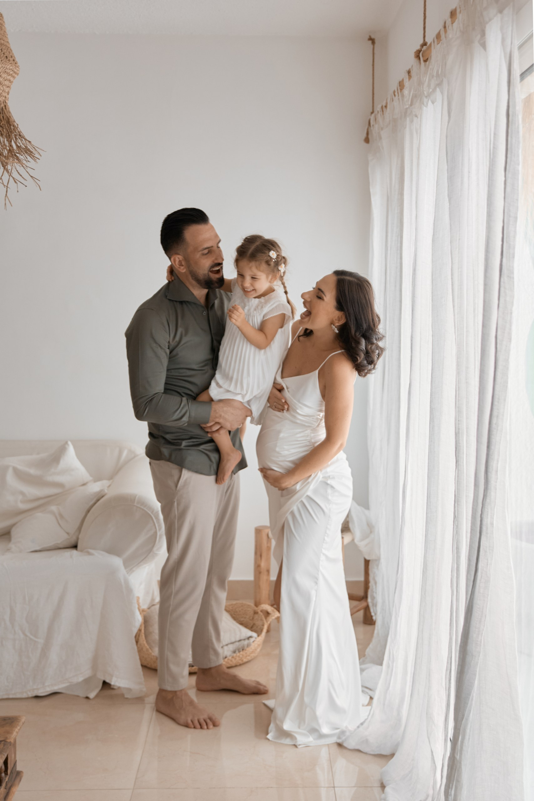 Happy family enjoying a moment at home, capturing the best maternity photo in Emirates with natural light and smiles