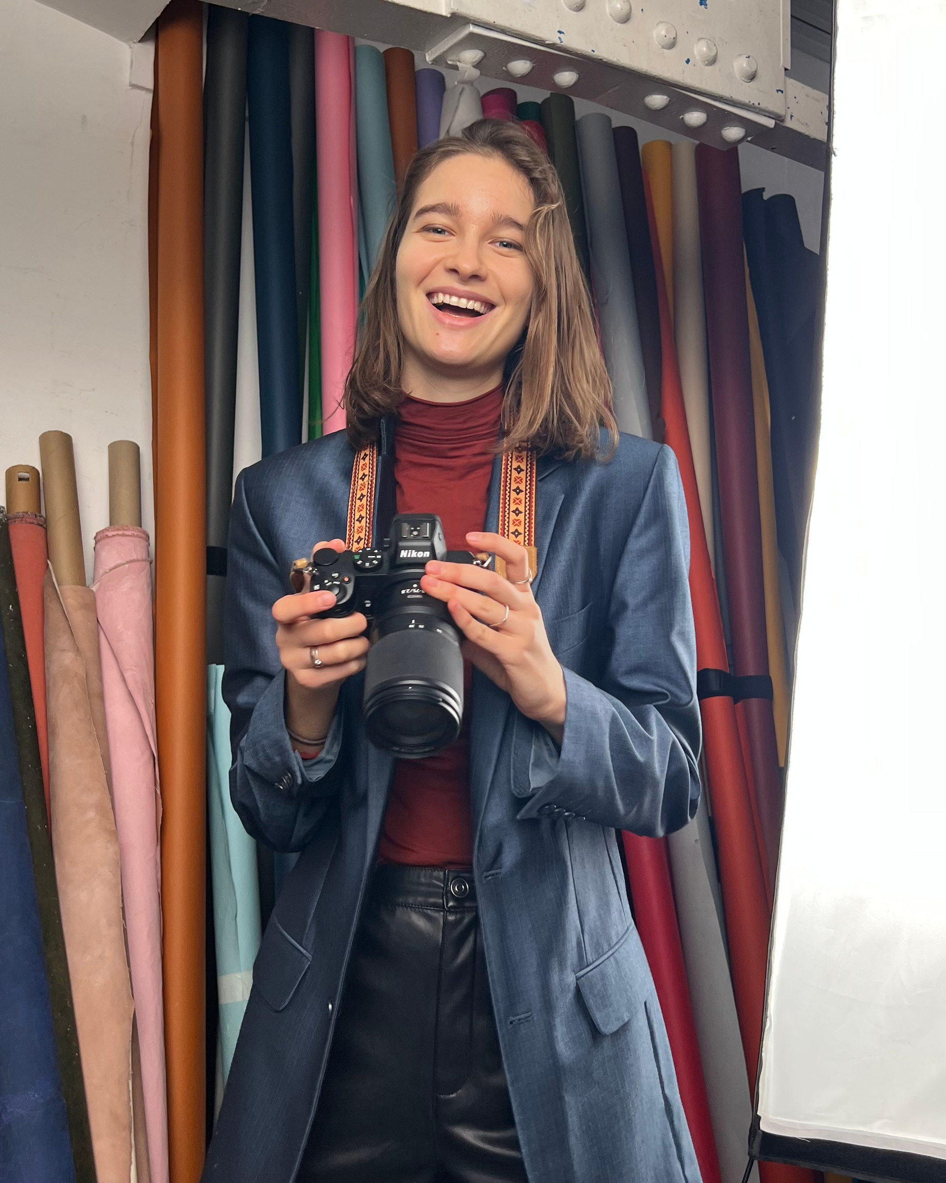 photographer Anasta fo in the studio with a camera in her hands