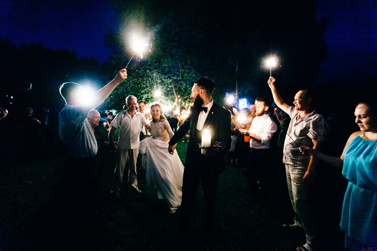 Гости на банкете в темном зале со свечами