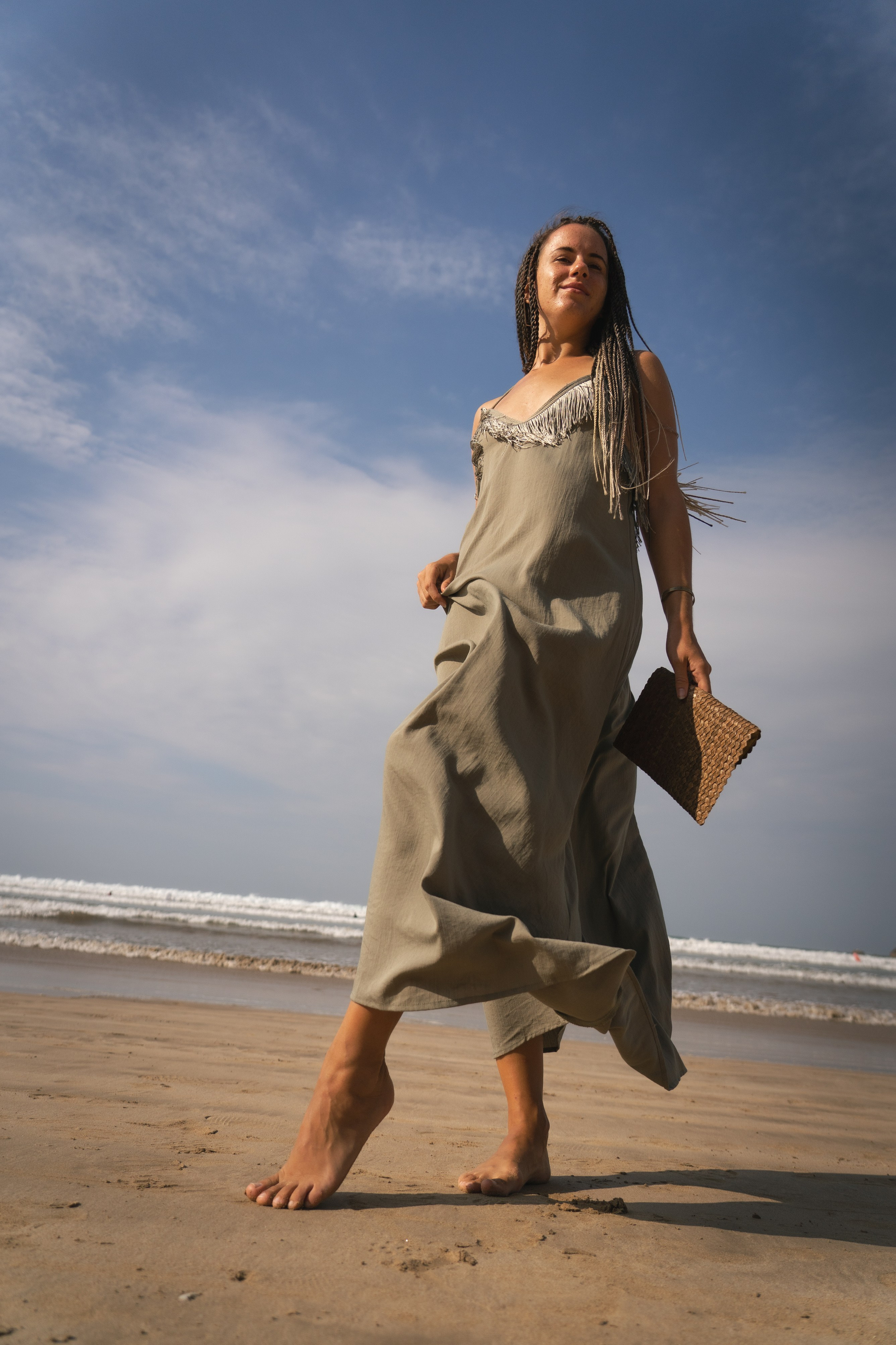 Girl in a long dress on the beach