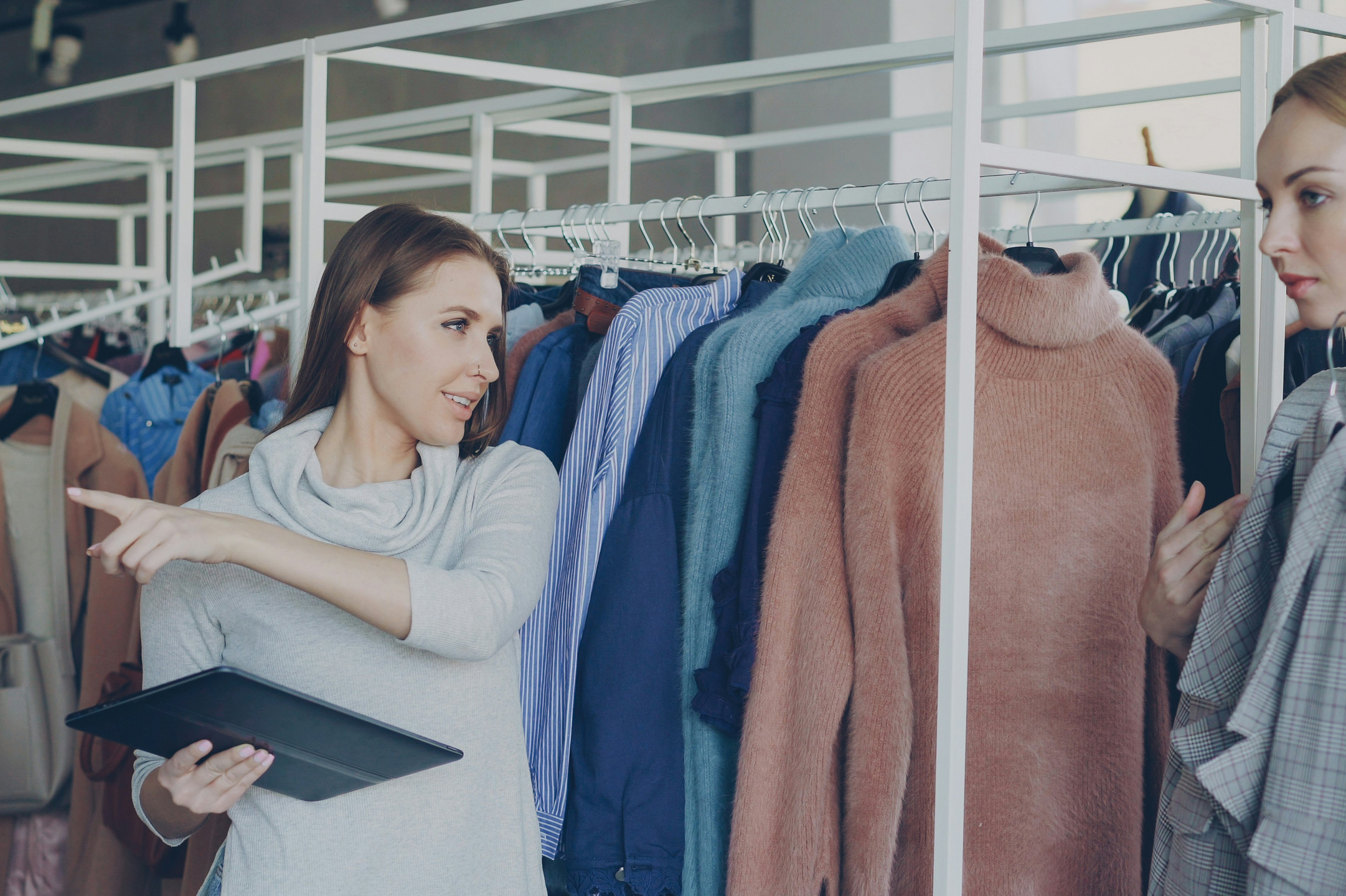 Personal shopping assistant helping a VIP client choose clothing