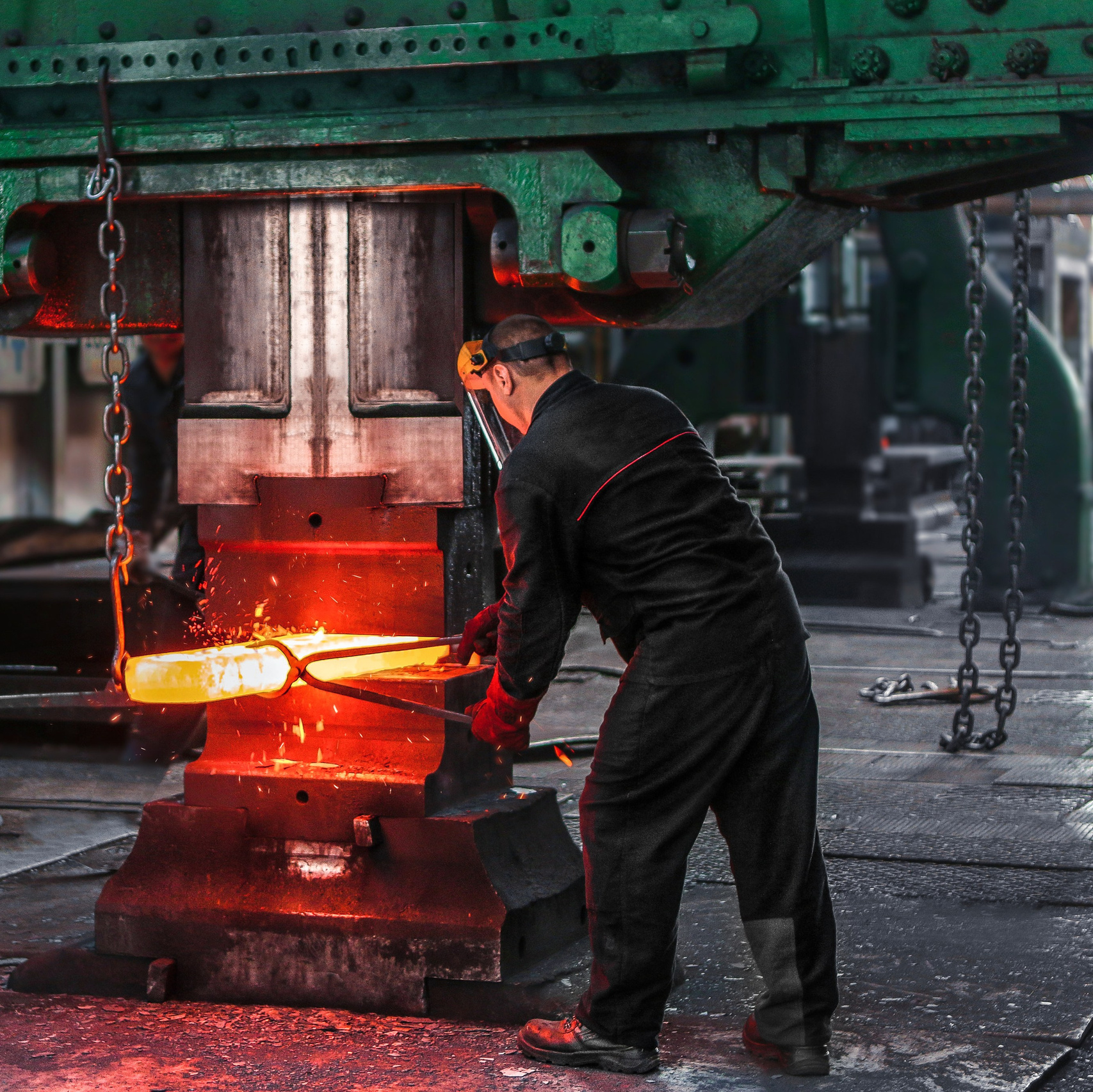 Металлургическое производство, работа кузнеца под прессом, промышленная фотосъемка на предприятии