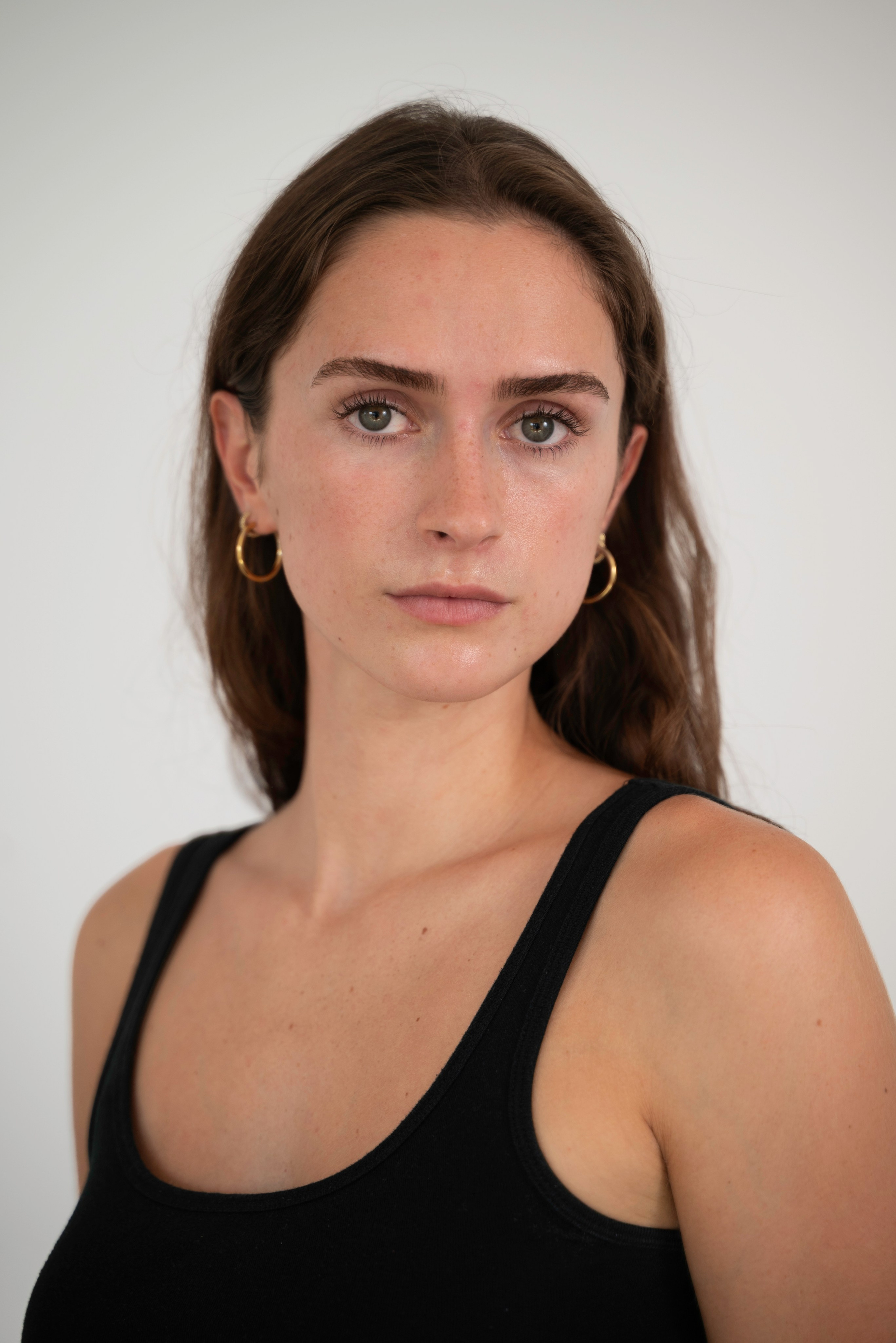 Natural model headshot in a black outfit, photographed by Anasta Fo in London