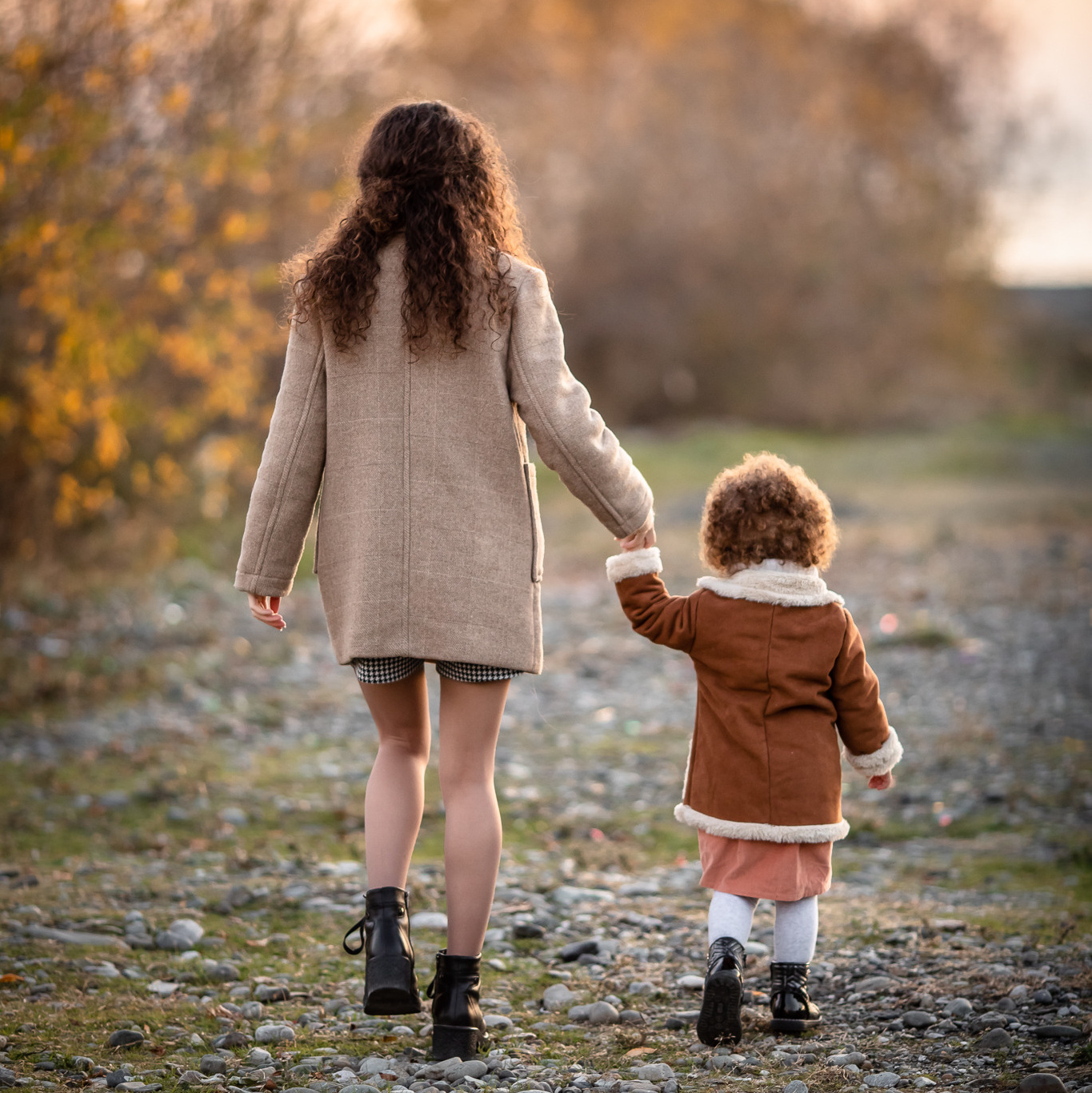 Мама с дочкой идут по берегу реки фото сзади