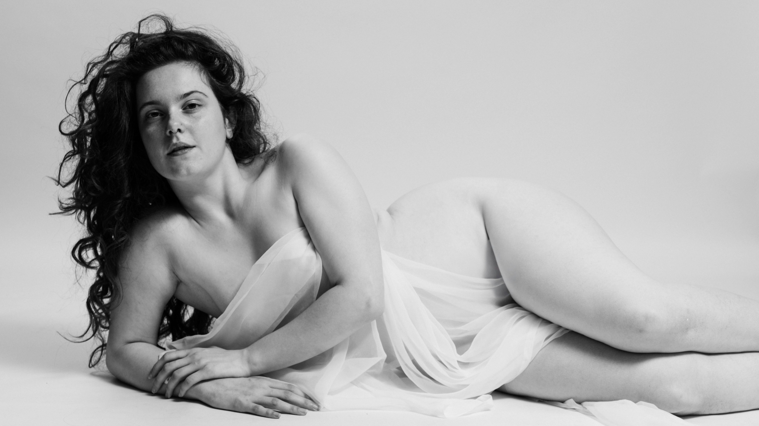 photo of woman with arms raised, natural confident smile