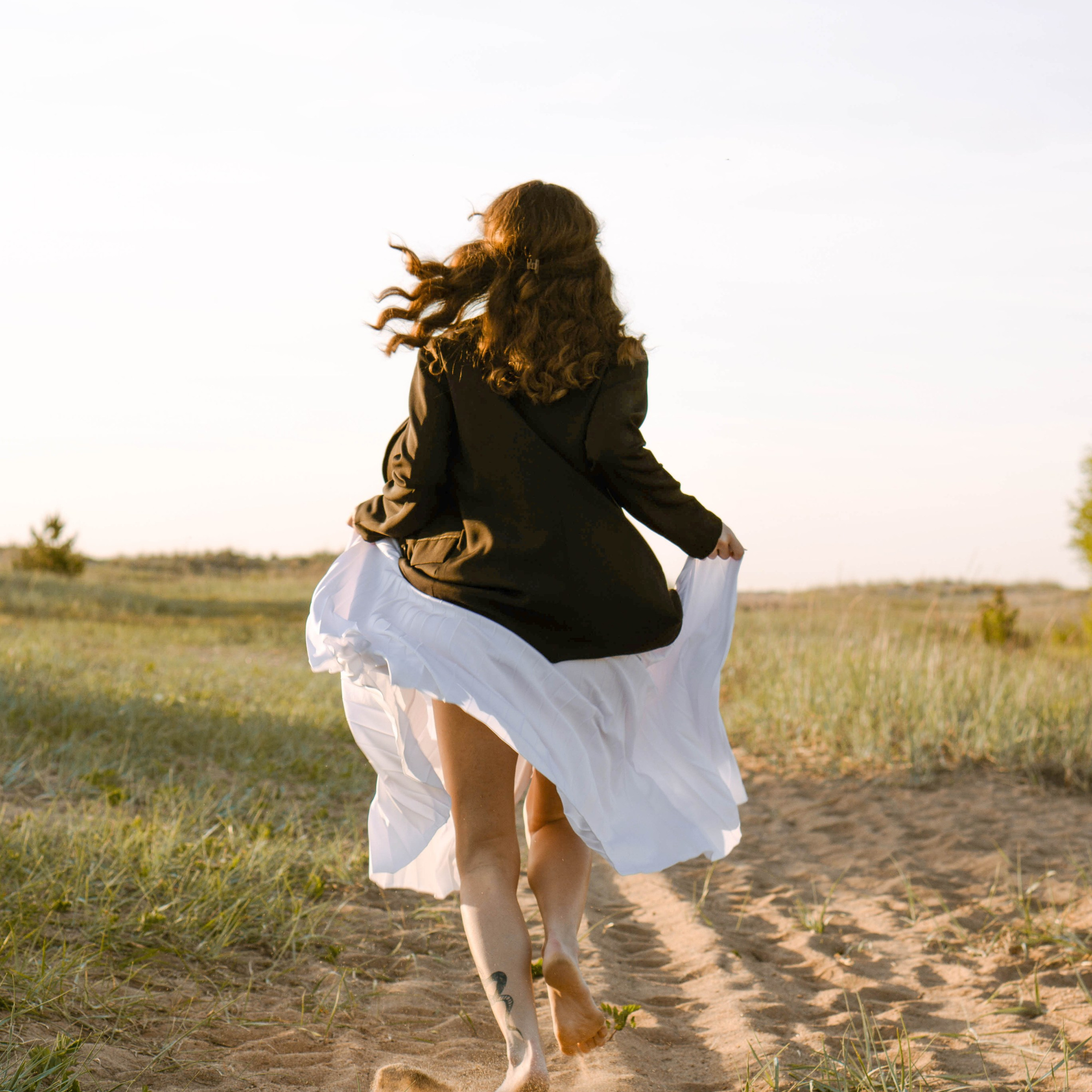 Девушка в белой юбке бежит по полу к финскому заливу