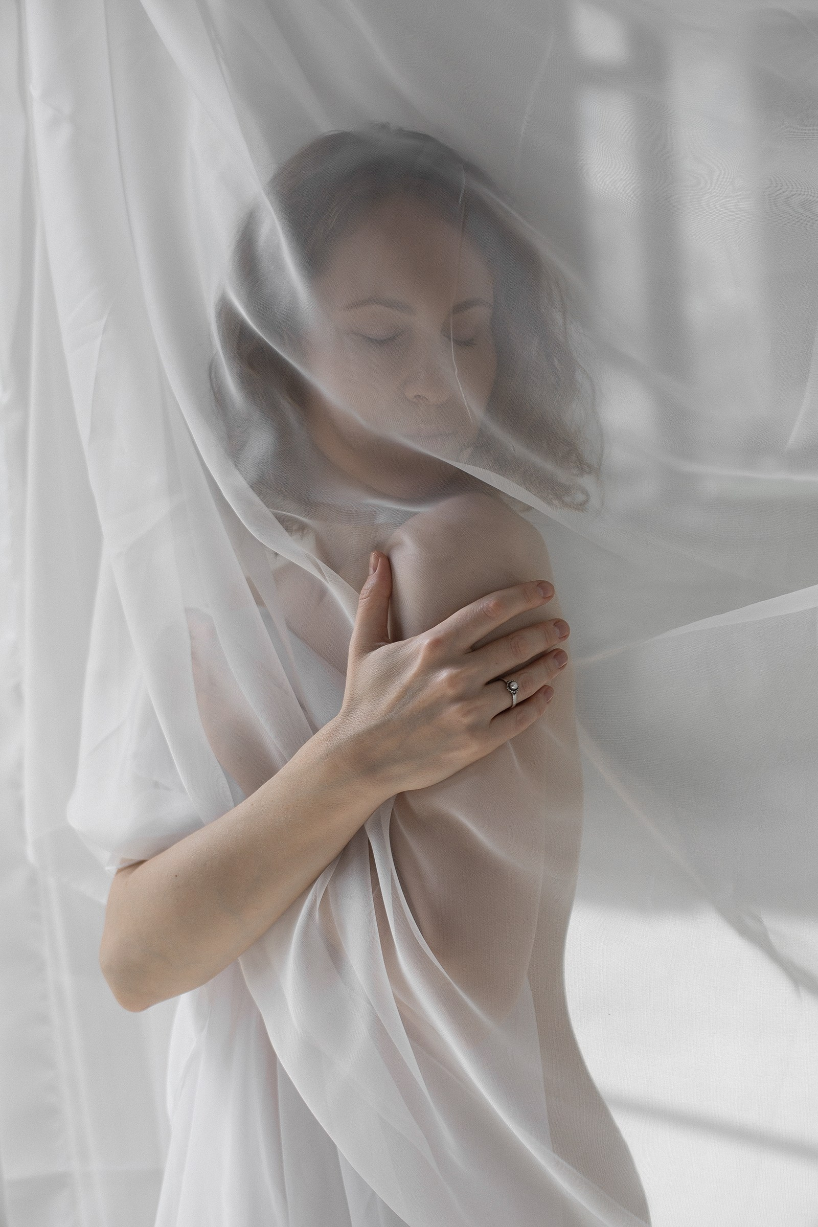 Женская фотосессия в студии с динамично развивающейся тканью.