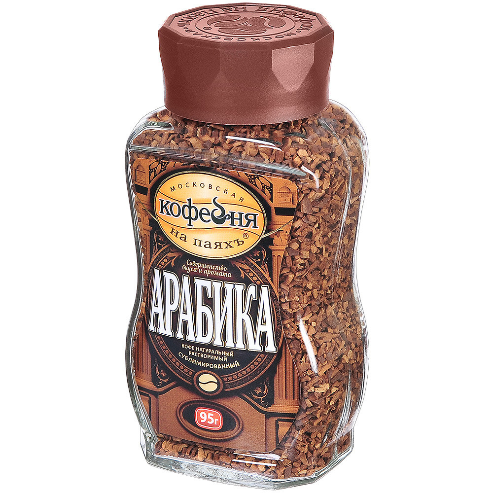 Быстрорастворимый кофе в стеклянной банке с коричневой крышкой на белом фоне.