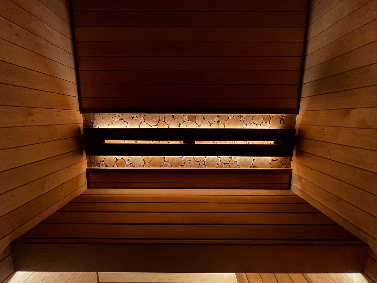 Уютная парная в Glorex Заневский. Компактная, но визуально просторная за счет парящих полков и горизонтального расположения светлой ольхи. SaunaTopMasters
