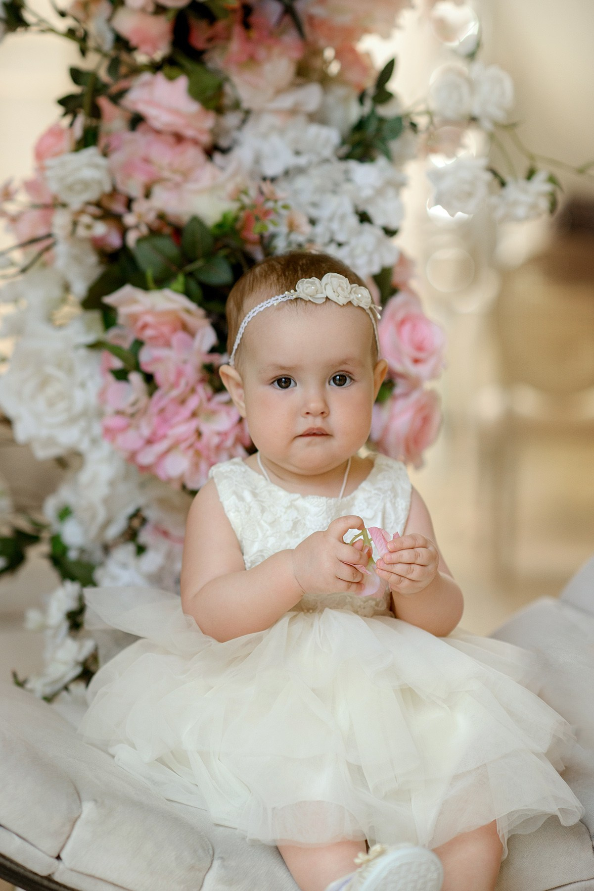 little girl in blooming arch. Photo shoot in the studio in the spring
