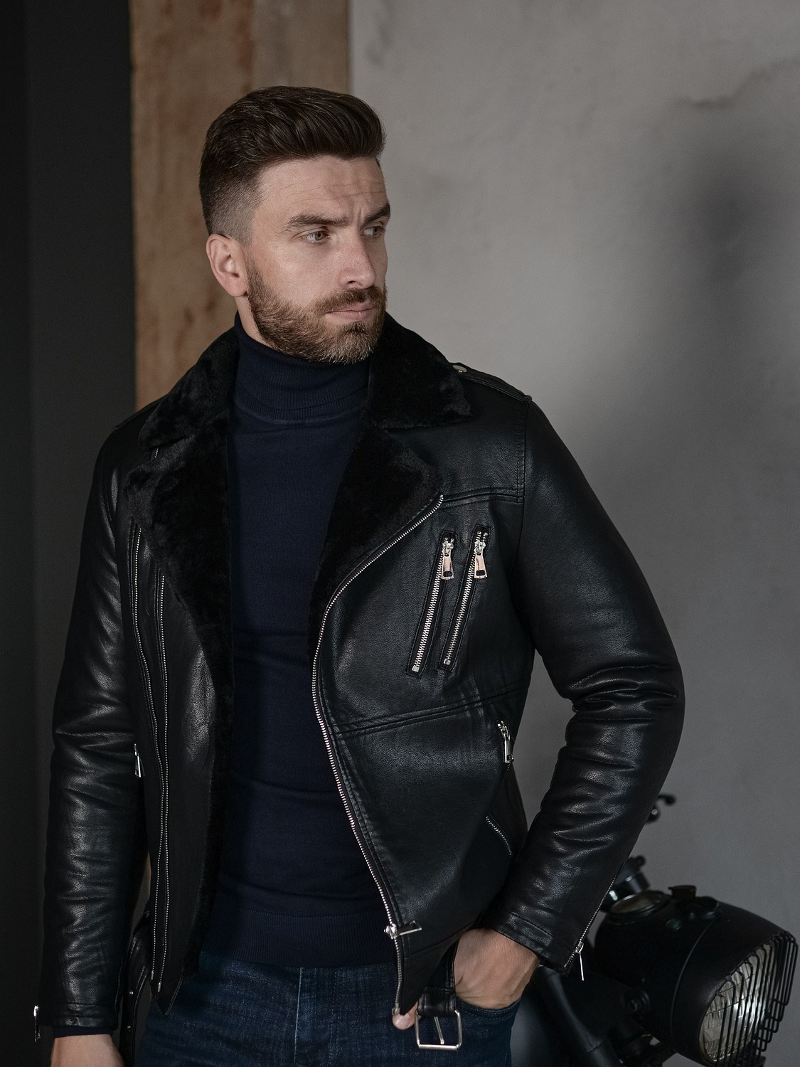 Мужчина в синей водолазке и теплой кожаной куртке