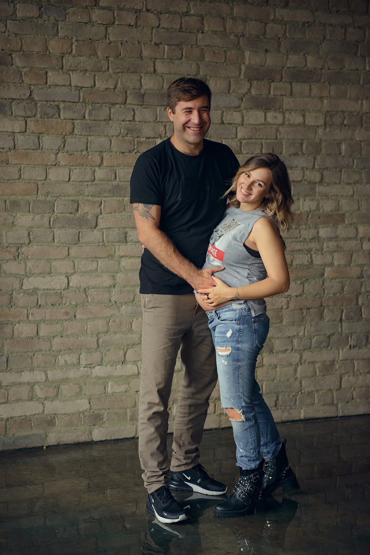 dad and daughter in a dark photo studio