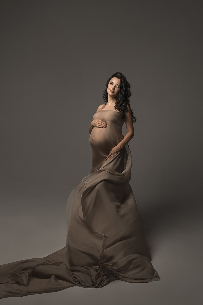 фотосессия беременной в фотостудии на темном фоне в красивом разлетающемся платье, фотография беременности, фотосессия беременных, портрет беременной