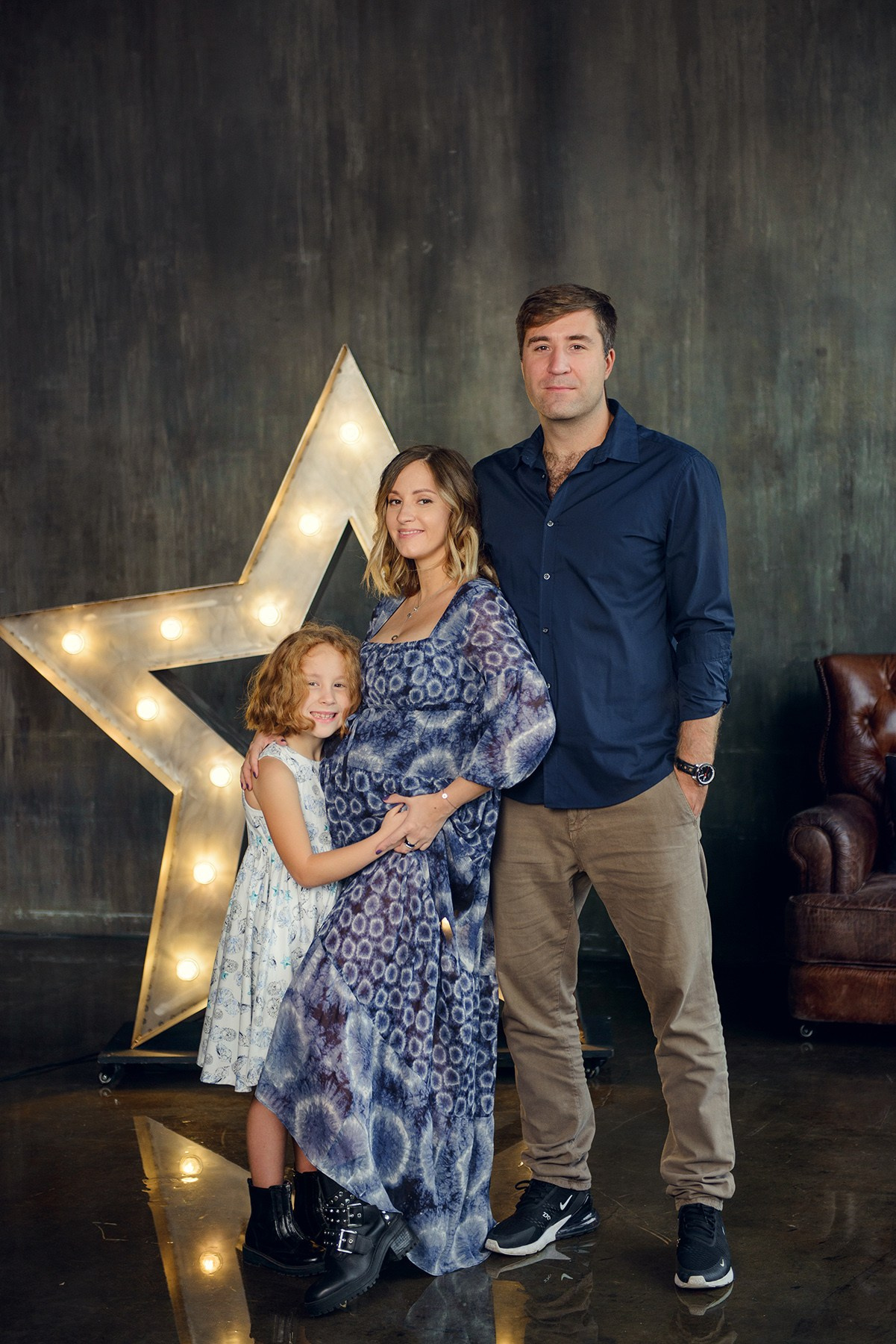 Family photo shoot with a pregnant woman in a loft studio, 