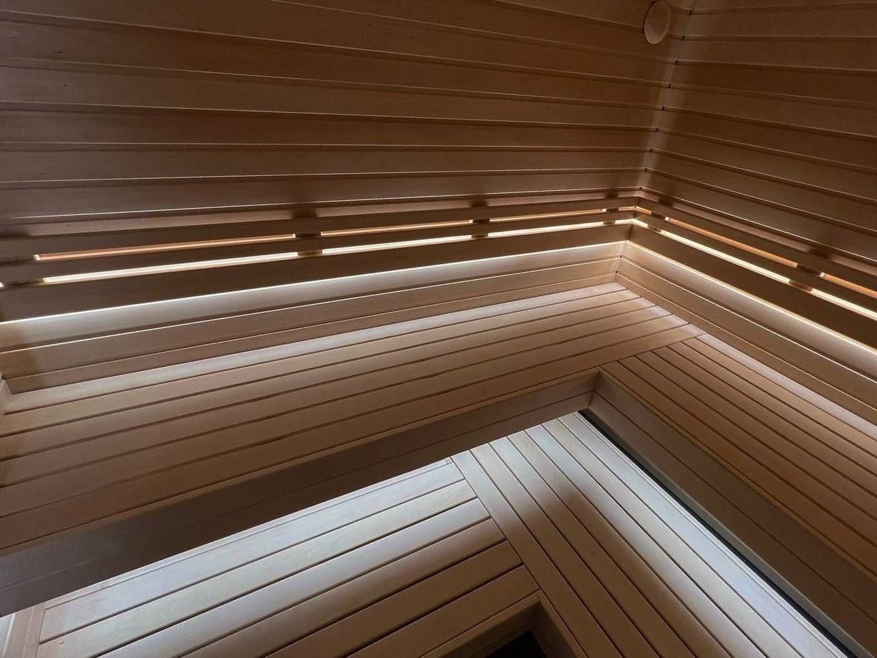 Сауна на морских террасах из осины и африканского абаши. Вертикальная укладка натурального камня-редко, но эффектно. SaunaTopMasters