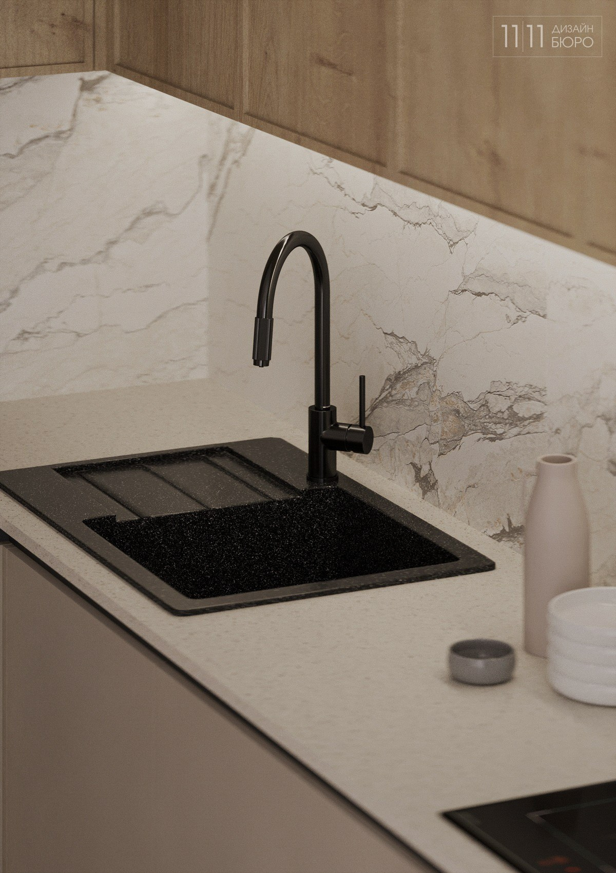 Черная раковина с черным смесиелем на светлой кухне