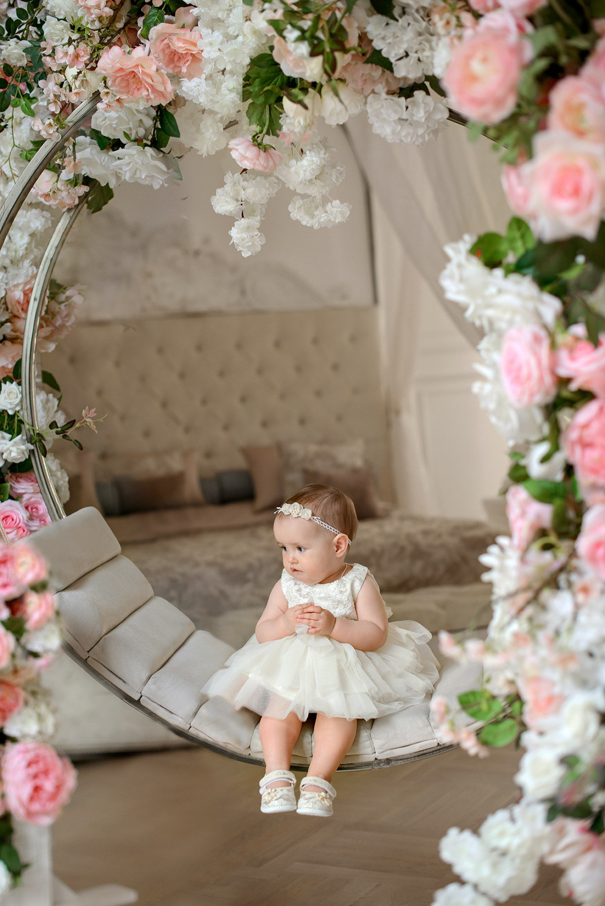 little girl in a white dress in  blooming. Photo shoot in the studio in the spring