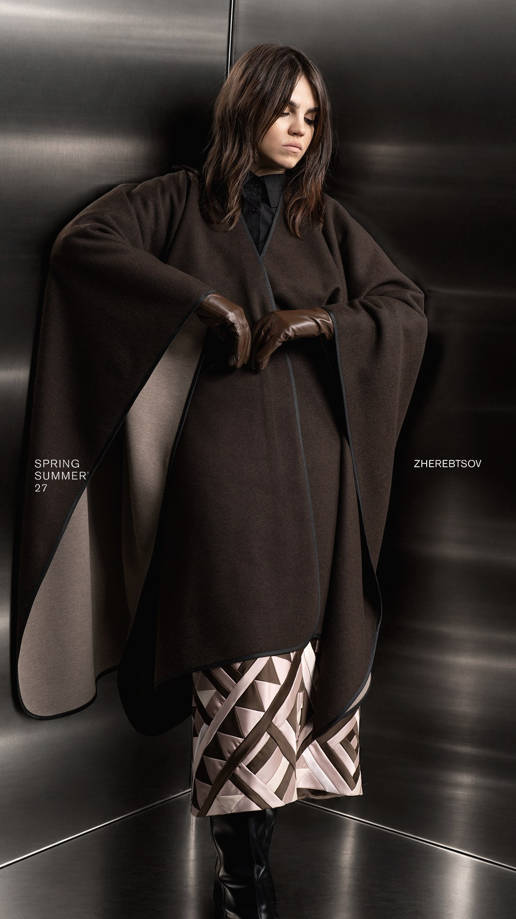 Fashion-съёмка коллекции ZHEREBTSOV Spring/Summer 2027 — тёмный кейп и геометричная юбка в металлическом интерьере, Алматы