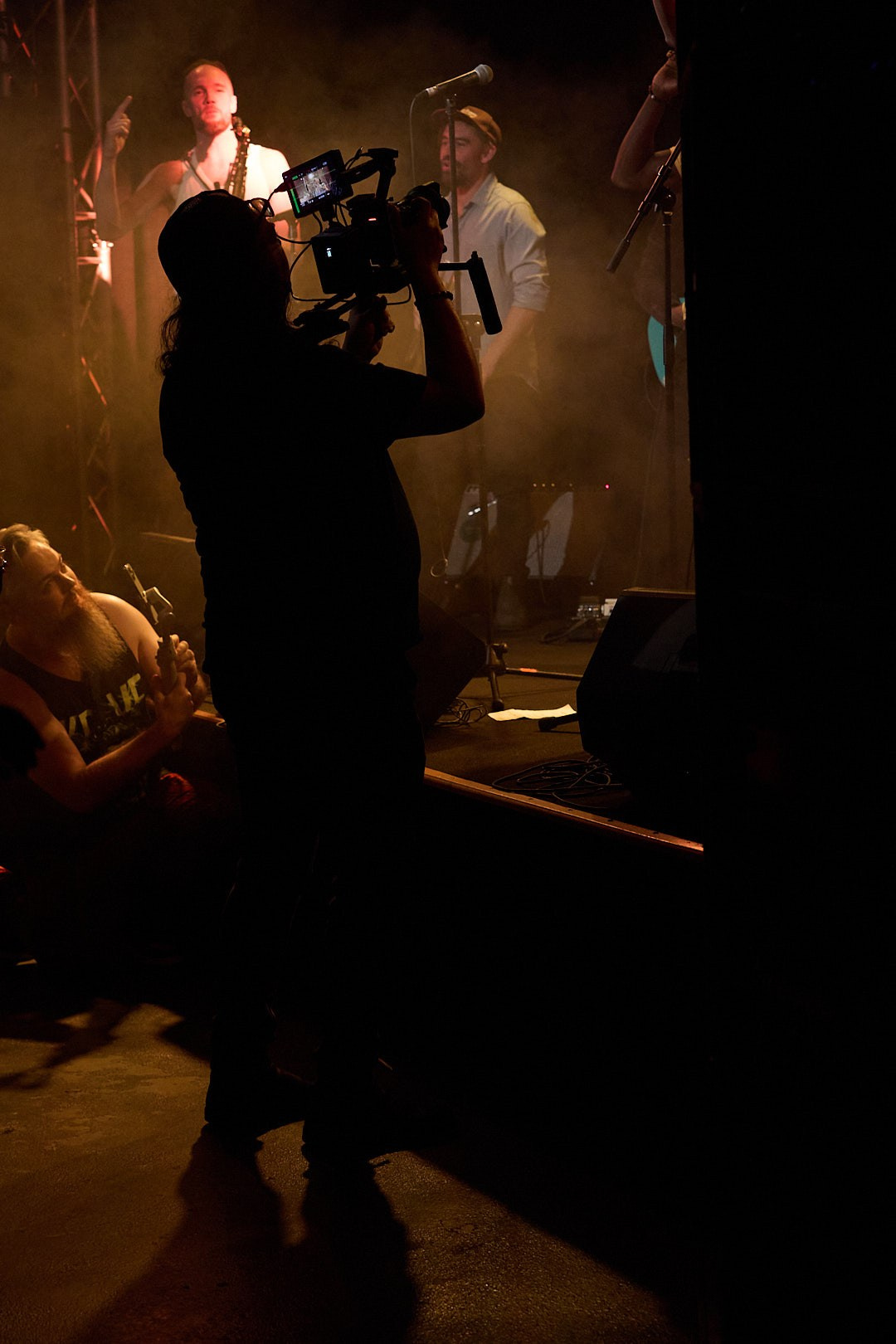 Cinematographer filming SUB-TRIBE on stage during their Red Earth Tour performance in Sydney, captured by photographer Maria Poleshchuk.