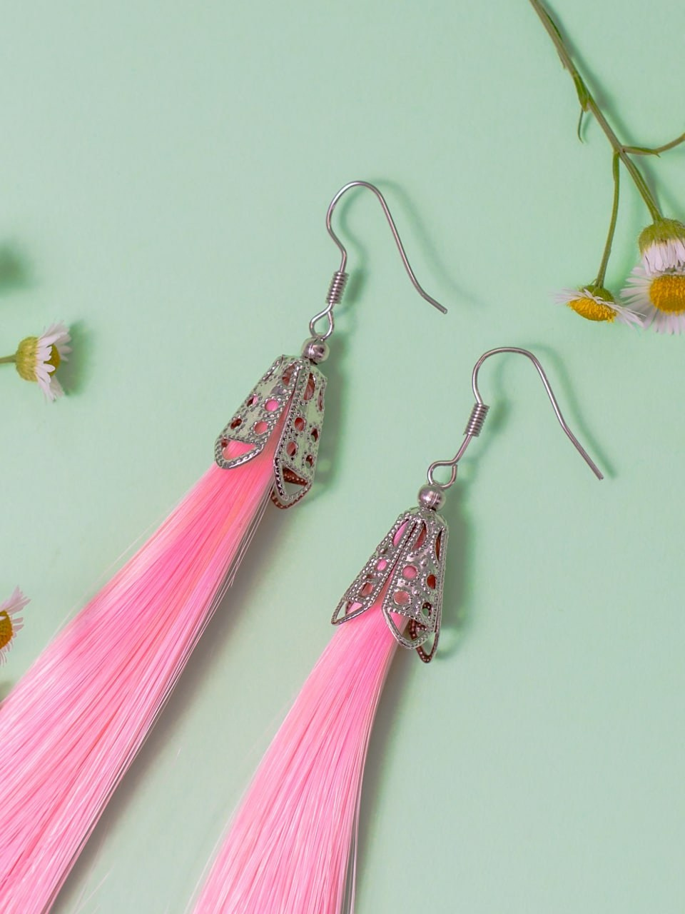 Предметная съёмка — серьги с прядями волос розового цвета.