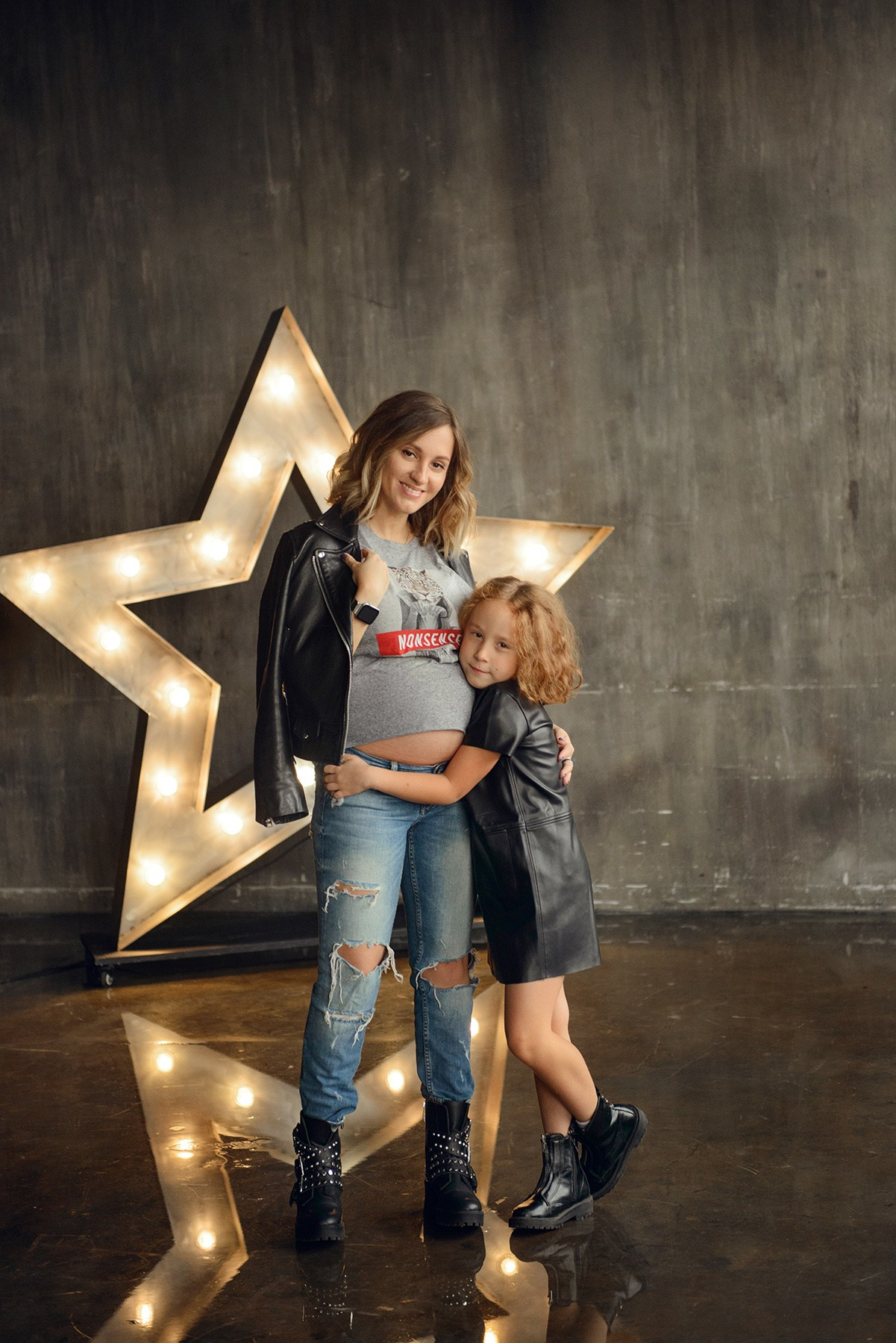 Family photo shoot with a pregnant woman in a loft studio, rock and roll style