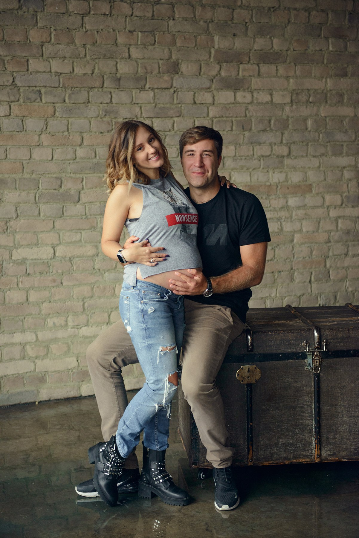 Family photo shoot with a pregnant woman in a loft studio, rock and roll style