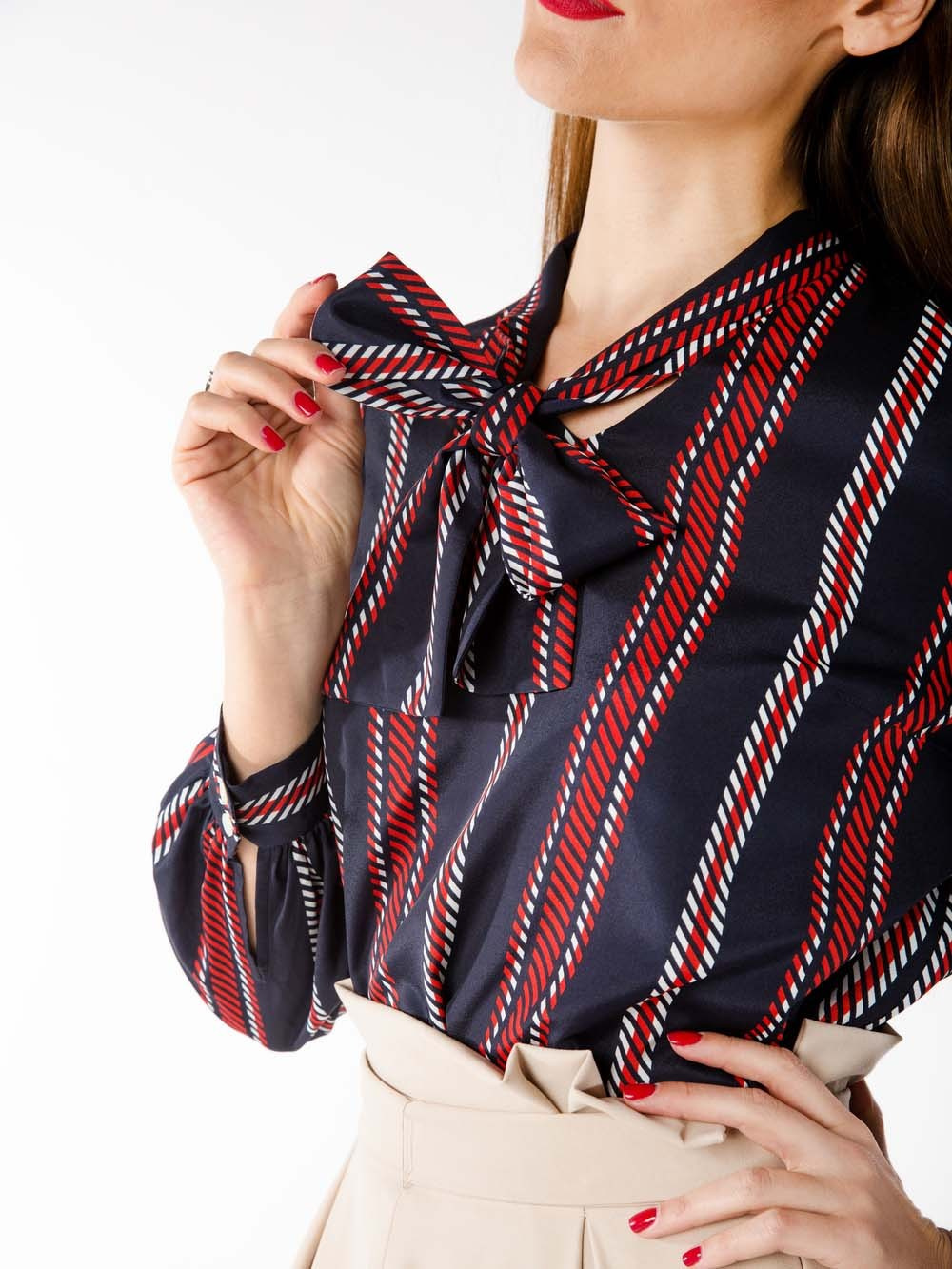 Девушка держит в руке воротник своей рубашки