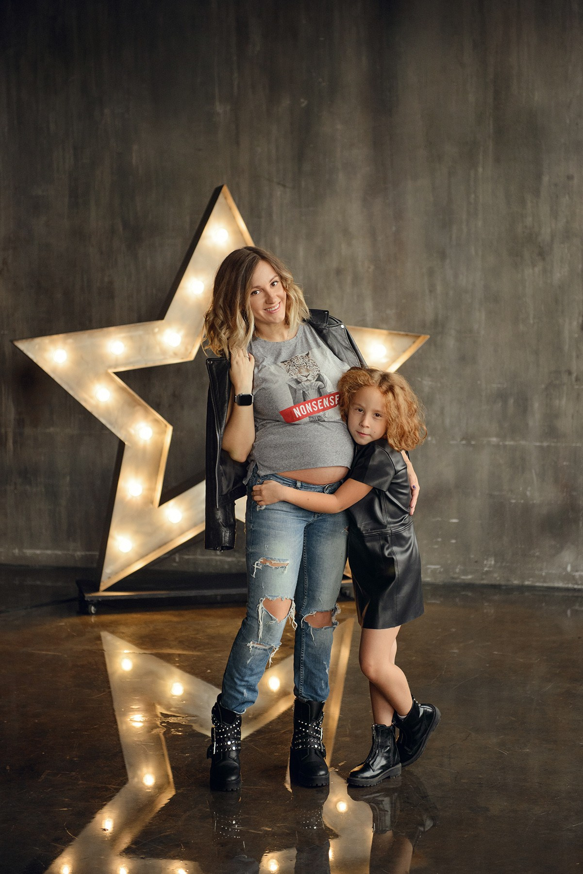 Family photo shoot with a pregnant woman in a loft studio, rock and roll style
