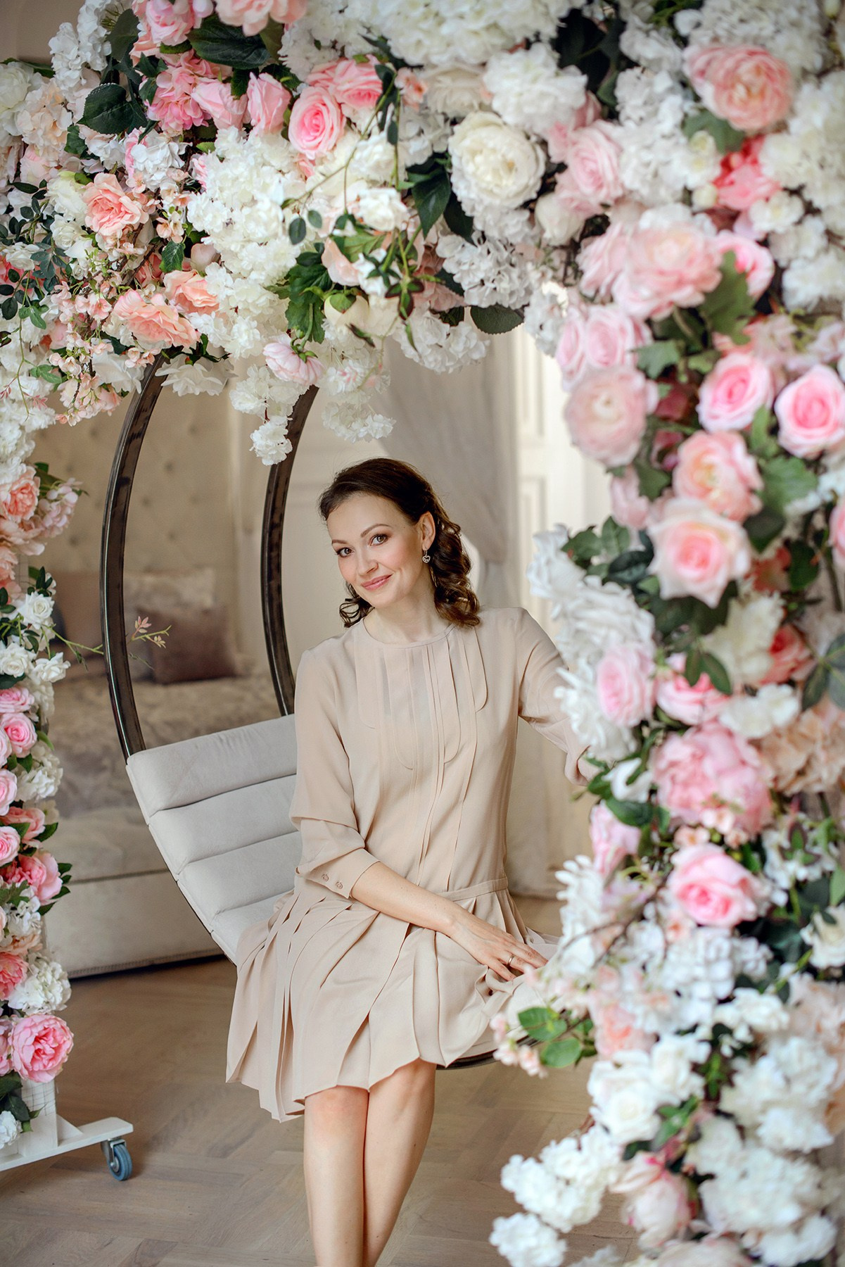 family in blooming arch. Photo shoot in the studio in the spring