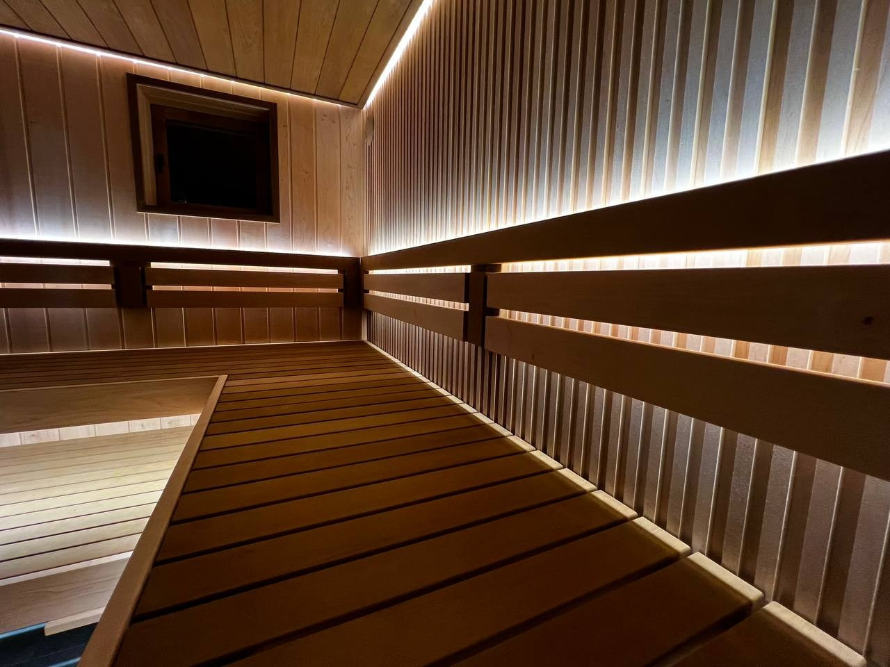 Компактная, но в то же время просторная парная в Петергофских дачах. Рациональное расположение полков и Easysteam в талькохлорите. SaunaTopMasters