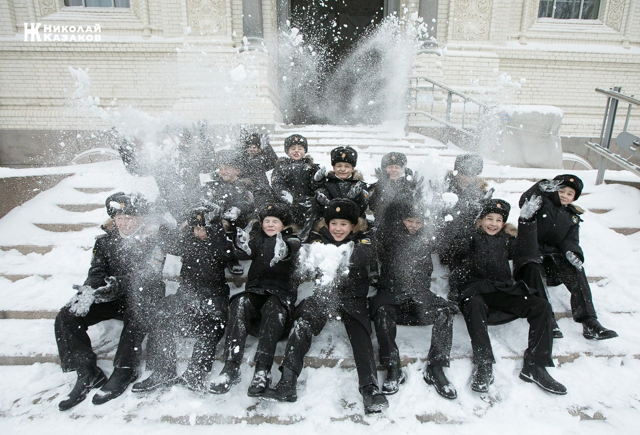Групповой портрет кадет Кронштадского морского кадетского военного корпуса играющие  в снег на ступенях  Морского собора 