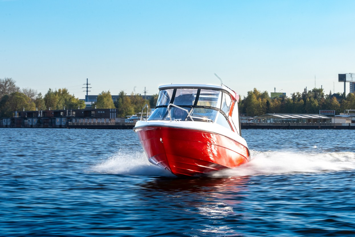 Катер Enigma рассекает волны на фоне голубого неба