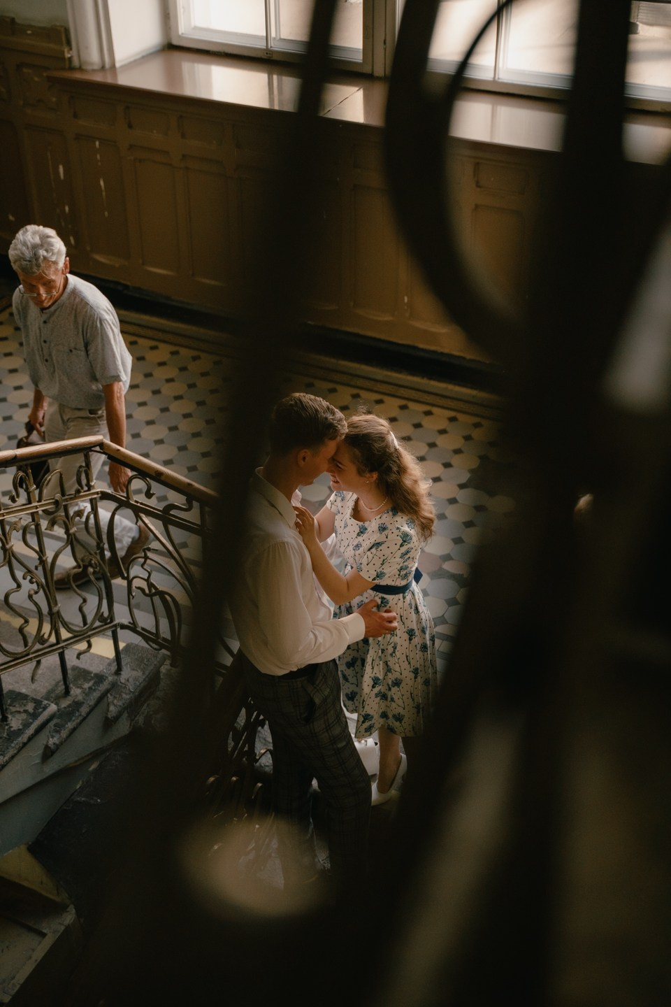 Кадр пары стоящей возле лестницы 