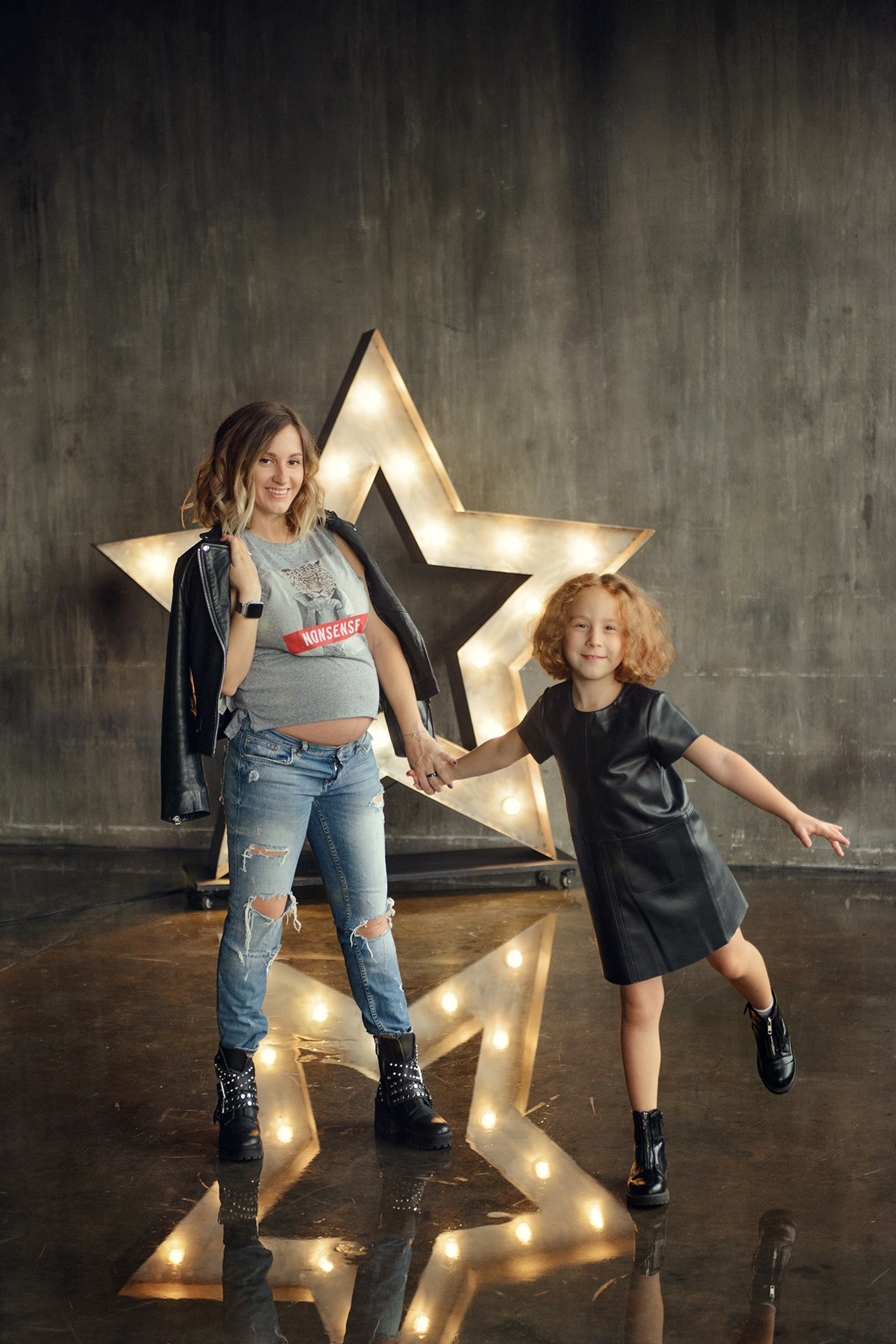 Family photo shoot with a pregnant woman in a loft studio, rock and roll style