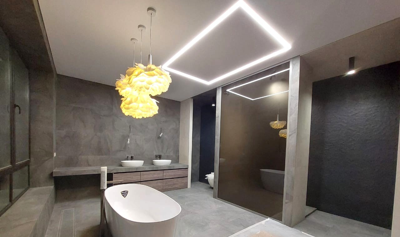 Светодиодные линии в потолке и декоративные люстры создают атмосферу уюта и роскоши.