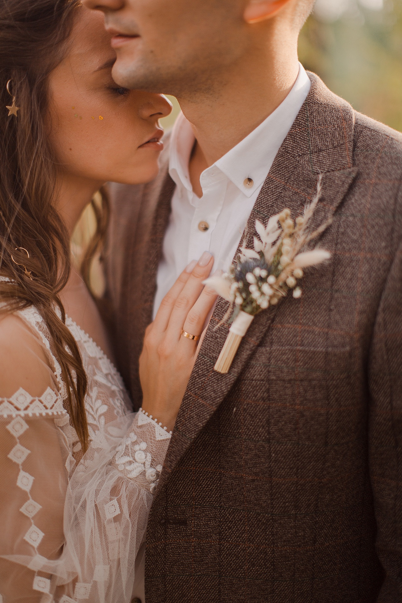 Невеста держит жениха за плечо, словно он ее лицемер и ее сила на этой красочной свадебной фотографии