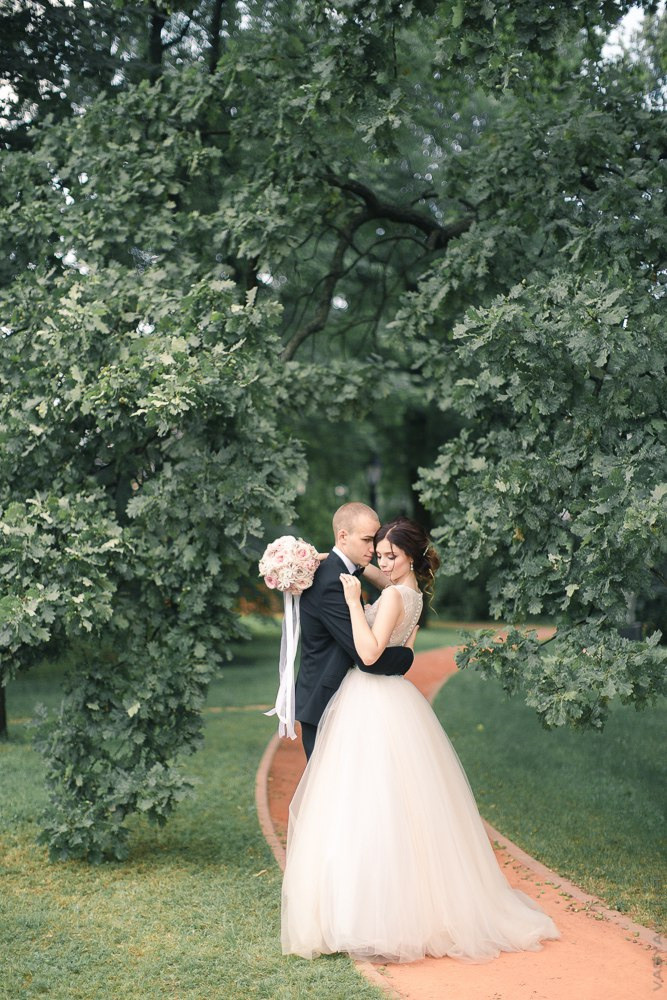 Молодая пара, танцующая на алмазном танцполе, с гостями, которые наблюдают за ними, почти в полной темноте