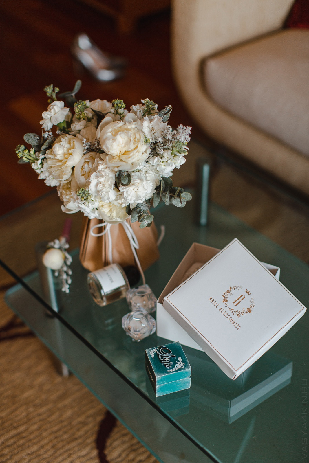 Невеста и жених стоят на дороге с узорными камнями, на фоне величественного дворца, на их гламурной свадьбе в Ярославле