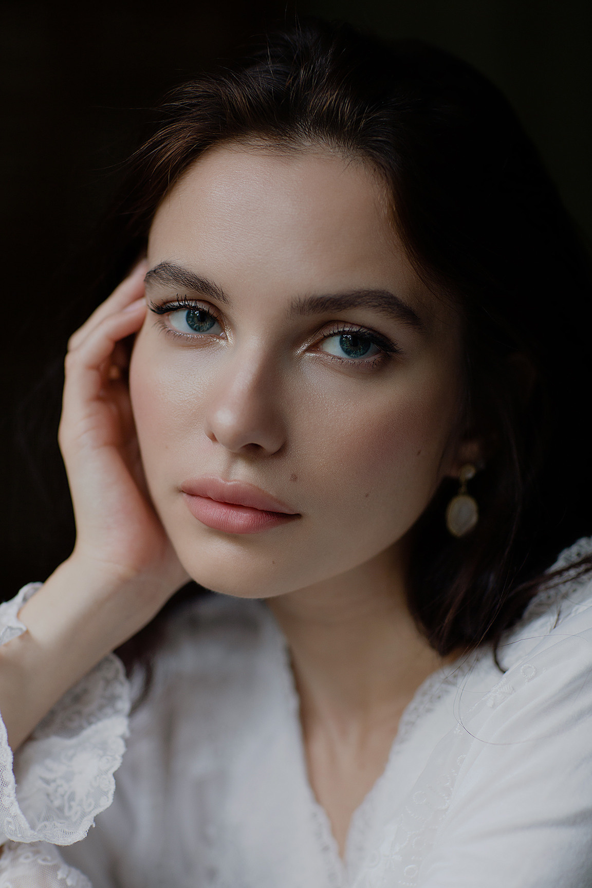 портрет модели на темном фоне с естественным освещением