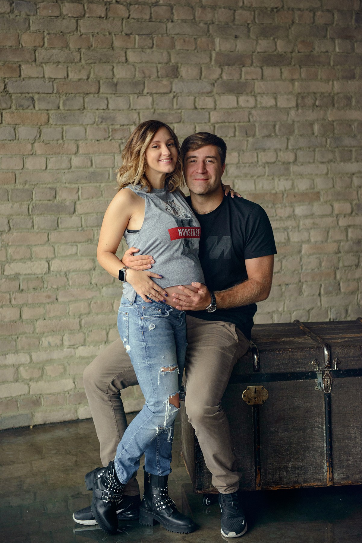 Family photo shoot with a pregnant woman in a loft studio, rock and roll style